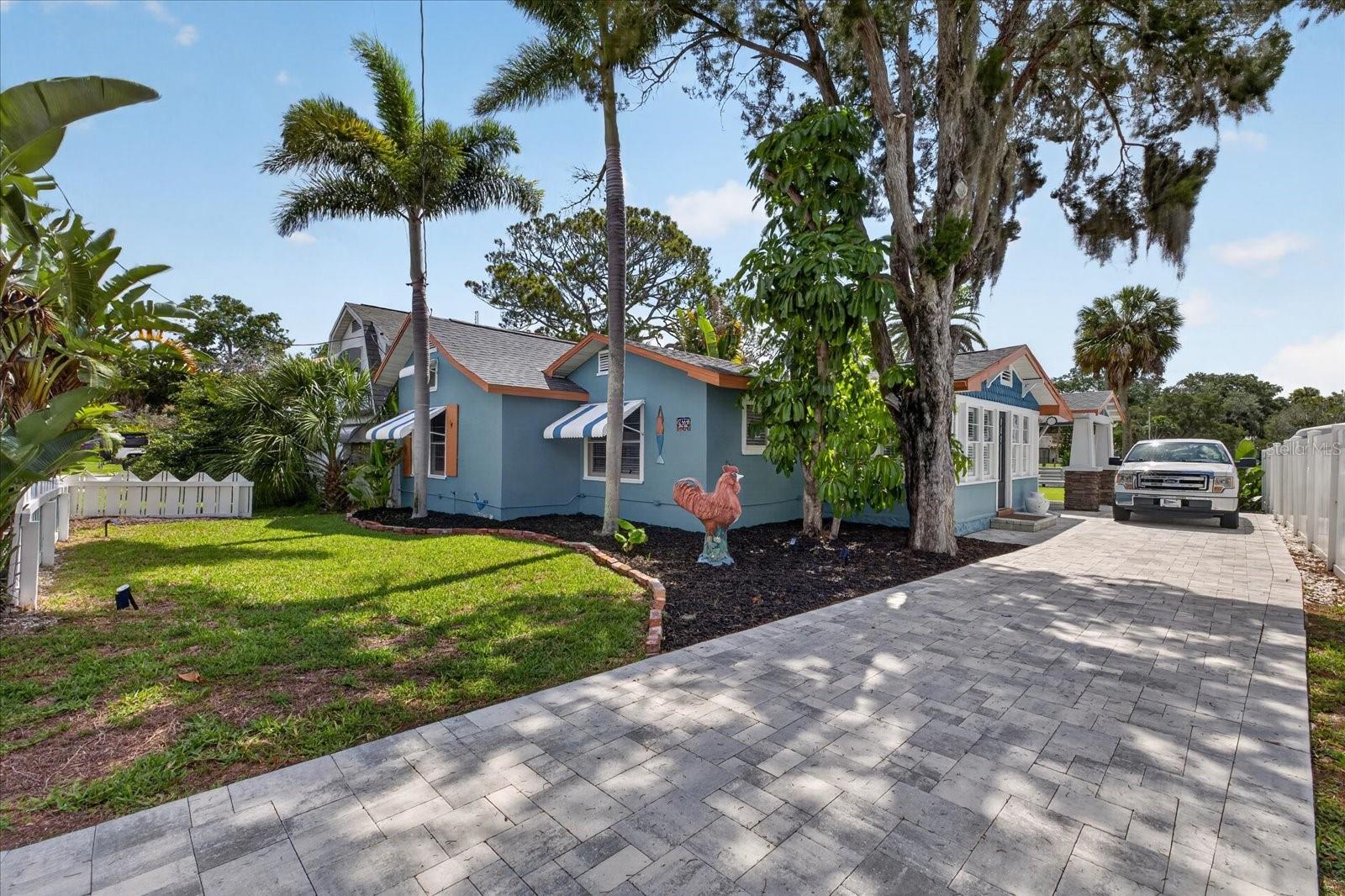 If you looked up “charming” in the dictionary, this historic home would surely be pictured! Known locally as “The Rooster House,” this COMPLETELY renovated 2-bedroom, 2-bath waterfront gem is filled with personality, character, and Old Florida charm. Being sold fully furnished, this home is truly move-in ready and would make the perfect full-time residence, seasonal retreat, vacation getaway, or income-producing investment property.

Imagine relaxing on your covered back porch overlooking the sparkling waters of the Cotee River and your huge pool-sized backyard, all while listening to live music drifting across the river from the Sims Park bandstand. Just down the street you’ll find local breweries, bakeries, boutiques, restaurants, and everything vibrant downtown New Port Richey has to offer.

Beautifully and tastefully upgraded throughout, this home combines historic charm with modern comforts. Special features include stainless steel appliances, granite countertops, breakfast bar seating, an ensuite primary bedroom-NEW BATHROOM, spacious guest bedroom, large guest bath, covered outdoor laundry area, and an expansive covered balcony perfect for entertaining.  

You’ll also love the additional storage space located in the attic, accessed by a beautiful decorative tile staircase that adds even more charm and character to the home.

Recent improvements include a NEW  ROOF in 2024, NEW PLUMBING, updated electrical work, subflooring and flooring, insulation, interior painting, NEW kitchen cabinets, New large kitchen window, new blinds and MORE!!

The exterior is equally impressive with NEW PAINT, a pavered driveway, pavered patio, NEW vinyl fencing, and beautifully landscaped grounds that provide both privacy and beauty. Outdoor enthusiasts will love the direct riverfront setting complete with a kayak/canoe launch and existing pilings already in place for a future dock.

Whether you’re searching for a unique waterfront lifestyle property or an extraordinary investment opportunity, this home offers endless possibilities to enjoy the Florida lifestyle while building long-term equity.

“The Rooster House” is truly as cute as a button and must be seen in person to fully appreciate its warmth and charm. Available now — come take a look and prepare to fall in love!