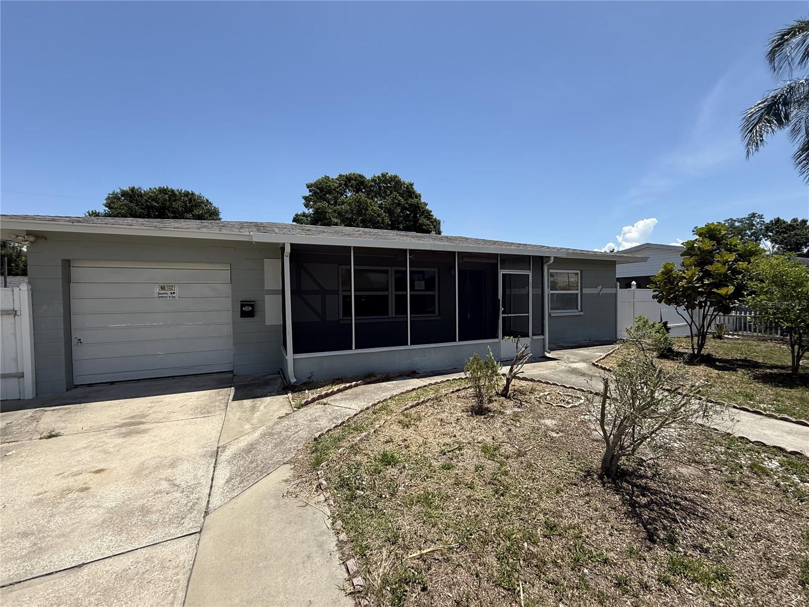 Great opportunity in St. Petersburg - with NO HOA or CDD! This home offers 3 bedrooms, 1.5 bathroom, 1013 square feet with 1 car garage. A screened front porch greets you at the entrance - perfect to enjoy a cup of coffee on a summer morning. Step inside to a generous sized living area with the kitchen just off this space. The kitchen includes updated white cabinetry, granite counters, modern backsplash and lighting. A secondary bedroom is directly off the kitchen separate from the other two bedrooms and perfect for guests or a home office. The other two bedrooms are found off the living room and share a full bathroom. The backyard is fully fenced with a wood gazebo. Great location, near restaurants, shopping and beaches. It's good to be home. This property may qualify for Seller Financing (Vendee).