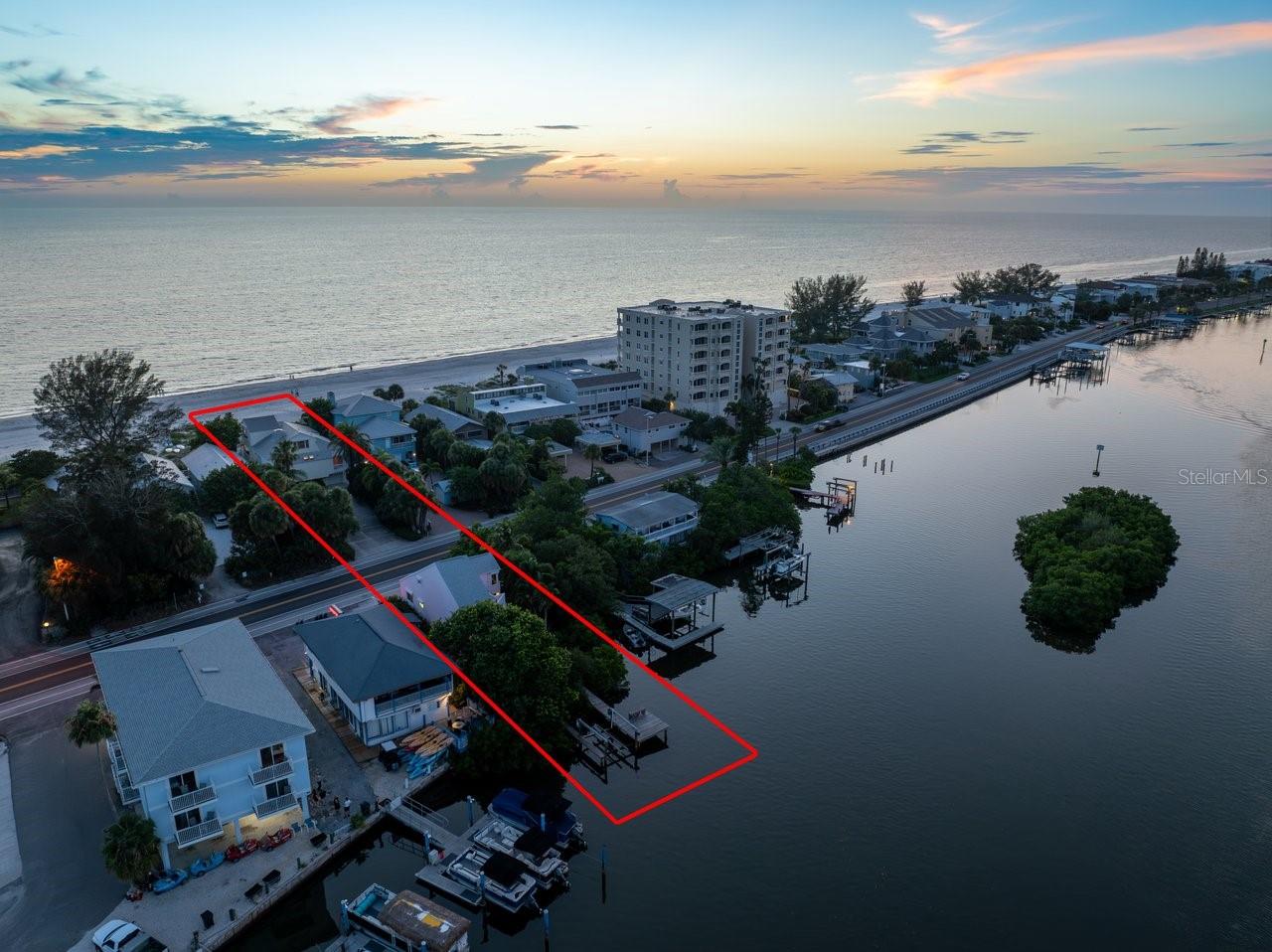 This is an extraordinarily unique and especially attractive Beach front to Bay front opportunity in Indian Shores, known for its prime location in what locals call “The Narrows” where lucky residents can enjoy both the pristine powdery sand beach and Gulf of Mexico sunsets as well as Sunrises and bay views from your guest home and boat dock on the bay and Intracoastal waterway. Exceptional custom built and only one owner, Dual-House investment or extended family compound opportunity where one can experience the ultimate coastal lifestyle with this rare chance to own two stunning homes. The larger home sits on the shore of the Gulf of Mexico with Key West vibes featuring three ensuite bedrooms. The Primary bedroom/bath retreat is perched on the third level all to itself. Extensive balconies on all levels and off all of the rooms welcome you to enjoy the wonderful breezes and vistas. The open great room living and kitchen area features soaring ceilings and captivating Gulf and Beach views. The guest home is nestled between the mangroves on the bayside with your private dock and boat lift along the deep water Intracoastal waterway. This captivating guest home would also make a wonderful office or art/music studio for those who need to have some separation to focus on work or their skill. The guest home features another 3 bedrooms and two baths again with the Primary bedroom/bath retreat being upstairs all to itself. The guest home kitchen and living area is also an open great room design with specular views of nature, the water and boats slowly passing by in the no wake zone. Indian Shores is on the western coast of Tampa Bay with easy access to Tampa and St Petersburg/Clearwater Airports. • This stunning property is walking distance or a short golf cart or bike ride to an array of restaurants, shopping, and amenities • Convenient yachting access to the Gulf of Mexico via Clearwater Pass to the north or Johns Pass to the south • Legal for short-term rentals are allowed making this a great investment opportunity if desired. There are two garage parking spaces in addition to under building parking and an enormous drive way with more than ample guest parking. Live in a vacation paradise full-time or part time with this extraordinary dream oasis. Property is only being offered as a combined package including both 20051 and 20052 Gulf Blvd.