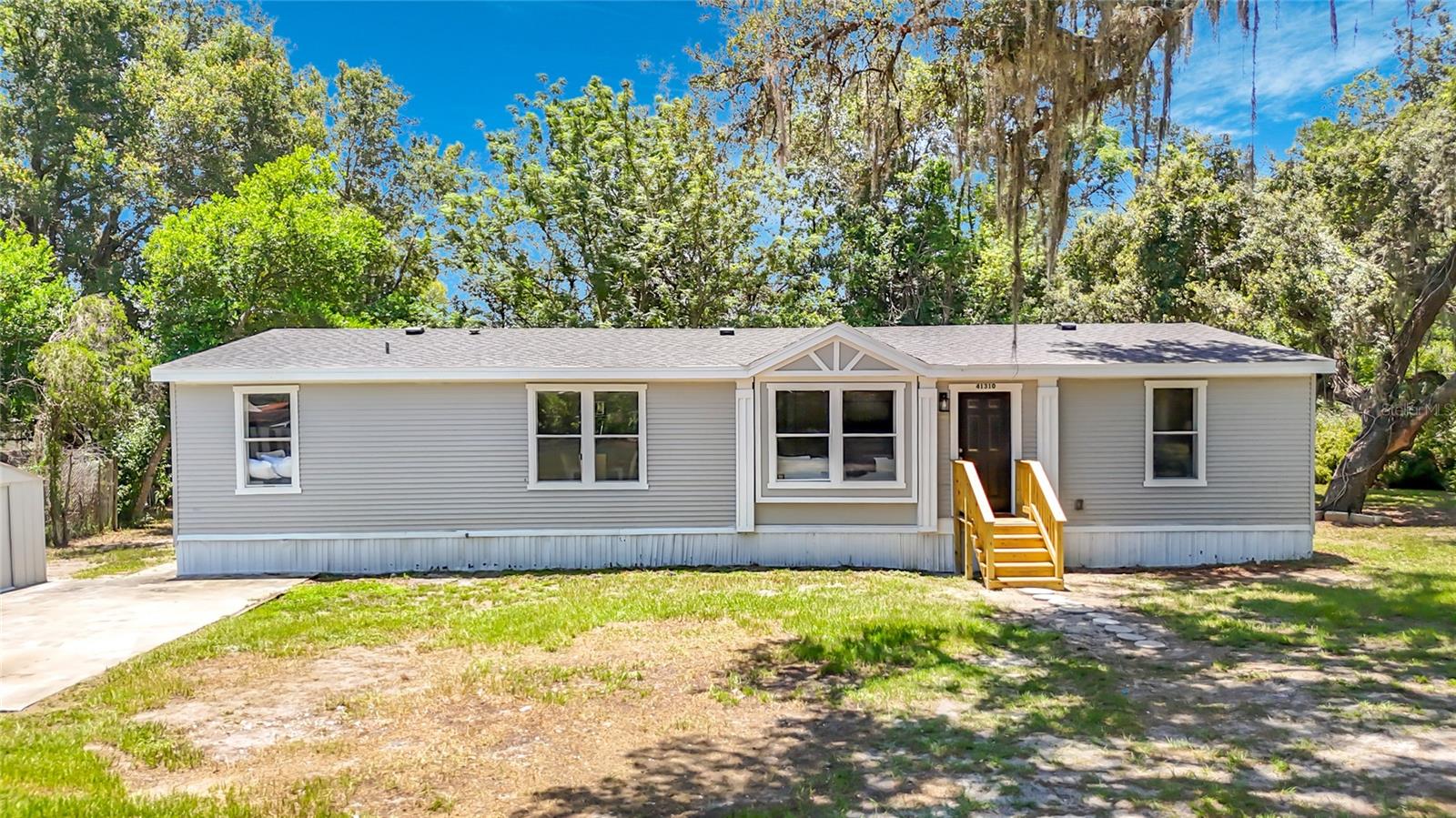Must-see opportunity in a highly desirable location. This fully remodeled 3-bedroom, 2-bath home offers 1,800 sq. ft. of beautifully updated living space and sits on a sprawling 1.06 acre lot, delivering the perfect blend of modern upgrades, privacy, and space. Recent improvements include a Brand New Roof, fresh interior and exterior paint, and new laminate wood flooring and carpet throughout. The open concept floor plan features a completely renovated kitchen, showcasing stainless steel appliances, quartz countertops, a large island with storage, and all-new cabinetry—ideal for entertaining and everyday living. Both bathrooms have been fully updated with new shower enclosures, fixtures, finishes, and lighting. The spacious primary suite offers a private retreat with an en-suite bath featuring dual sinks, a walk-in shower, a brand-new standalone soaking tub, and a huge walk-in closet. Enjoy outdoor living with a massive yard, and two sheds—perfect for storage, hobbies, or additional workspace. With no HOA, there is plenty of room for boats, RVs, or trailers. Electrical was upgraded in 2022. Conveniently located at the close to shopping and dining. Located in Flood Zone X (no flood insurance required). Ideal for buyers seeking space, privacy, acreage, and modern finishes—this property checks all the boxes.
