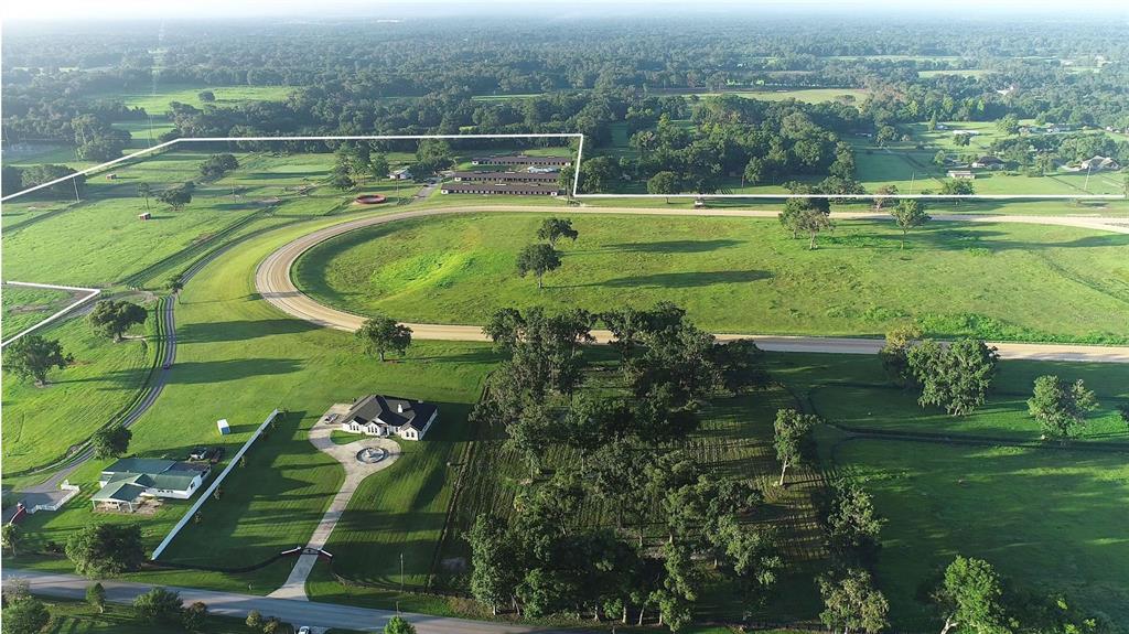 Located in the prestigious NW Marion County area, just 8.5 miles to the World Equestrian Center with easy access to I-75 for traveling, plus convenient to additional amenities.  A property that is a must see to appreciate all the beauty and features it has to offer.  80+/- Acre, State of the art equestrian facility with main residence and guest/ employee housing, 4 barns - 104 stalls, ¾ +/- mile racetrack, Eurociser, round pen plus plenty of lush green paddocks. 
This estate includes a 4 bedroom, 3 bath home, built in 2016 with over 3,700 SF of living area.   Open floor plan is light and airy.   Formal living has double sided, wood burning stone fireplace, built in bookcases, family room, formal living room, formal dining room, kitchen, plus recessed ceilings throughout main living areas.   Kitchen features custom cabinets, granite countertops, walk in pantry, stainless steel appliances plus a cooktop.  Raised countertop seating area in kitchen.  Family room and dining area with double recessed ceiling, large windows, and access to the rear patio.  Spacious owner’s suite with ensuite bath which features double vanities, Jacuzzi tub plus shower.   Second bedroom with access to full bath.  Third wing of the home has 2 additional bedrooms and 1 bath.   Attached spacious two car garage. 
The second residence has been remodeled to include two apartments for staff or guests.  
Equestrian facilities include 3 concrete block shed row barns with 32 stalls per barn which have been renovated with new paint, new roofs in 2021, clay, cupolas, and new plywood.  Each barn has office/ tack room and restroom located on west end of the barn, and LED lighting.   4 Brand new wash racks. 8-Stall center aisle wooden pony barn with metal roof.   Additional improvements include:  8-horse Kraft Euorciser with metal roof, new round pen with viewing platform, multiple shavings pits, plus loading ramp.   ¾ +/- Irrigated racetrack with starting gate, 11-zone irrigation for the track and viewing stand.     New 4 board fencing on the property.  18 Lush green paddocks and pastures of various sizes.