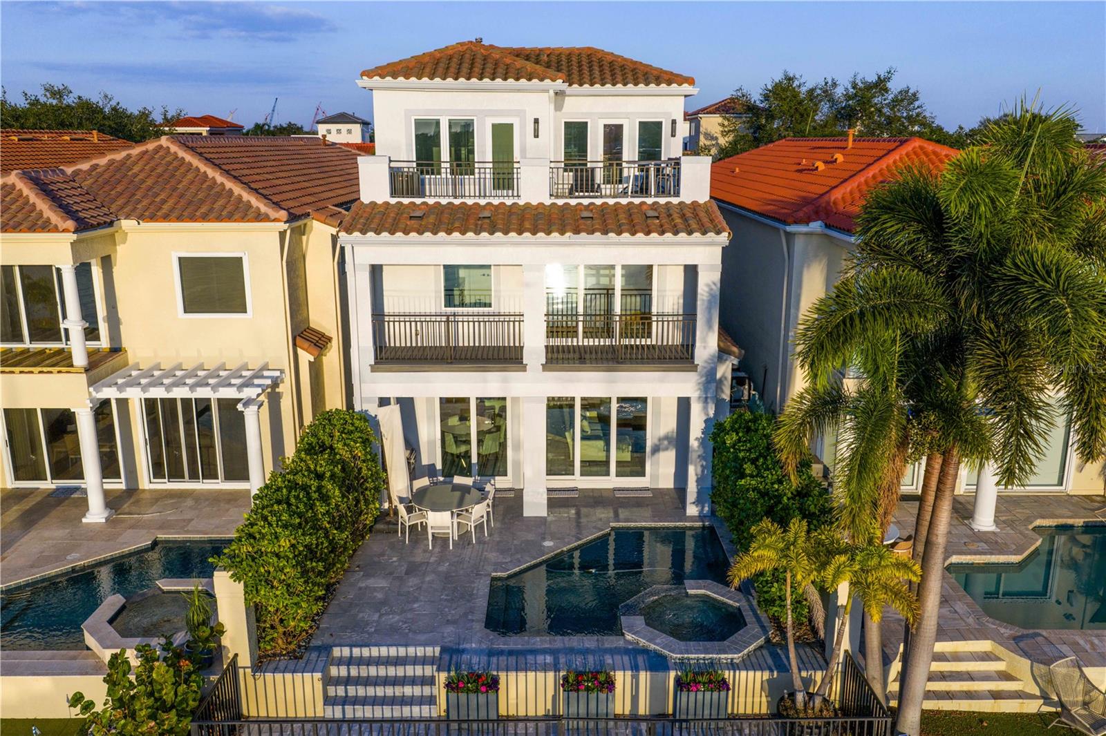Live where the city meets the water. Welcome home to this fully reimagined single-family home, meticulously renovated top to bottom by renowned Soleil Design. The thoughtful design lives in the fine details. A set of double doors opens to a warm, inviting entryway revealing the home’s showstopping glass elevator and open-concept living space. The chef’s kitchen is a work of art, outfitted with double Wolf ovens, a Wolf six-burner gas cooktop, a Sub-Zero 60" refrigerator, and a separate wine and beverage fridge—your guests will never go
hungry or thirsty. High-impact doors and windows flood the space with natural light and frame views of the sparkling PebbleTec pool with AquaLink system, outdoor kitchen with gas grill, and a private boat dock with lift and brand-new seawall. Functional and custom built-ins can be found throughout the home in the family room, office and upstairs. To complete the first floor living space is an office or optional fifth
bedroom with adjacent bathroom and the first of two laundry utility rooms. Whether you take the stairs or glide up in the glass elevator, the second and third floors continue to impress. The split floor plan gives the primary retreat a wing to itself, complete with a private balcony overlooking serene water views, a double-vanity bathroom, walk-in closet, and a soaking tub positioned to capture its own waterfront
vista. Additional bedrooms are beautifully appointed, and the second floor features a secondary laundry room for everyday convenience, along with the home’s integrated smart-home systems. Ascend to the third floor and discover a flexible bonus space—perfect as a guest suite with a full bath or an entertainment lounge that opens onto a rooftop deck made for sunset gatherings.
Harbour Island’s 24-hour guarded gates ensure serenity, yet you’re mere steps from Tampa’s vibrant Riverwalk, Bayshore Boulevard, Water Street, and the city’s premier arts and dining districts. Commuters appreciate quick access to I-275, the Lee Roy Selmon Expressway, and Tampa International Airport, making every aspect of daily life effortless. Move right in and begin living the waterfront dream you’ve always
imagined—sunsets, sailing, and sophisticated entertaining await.