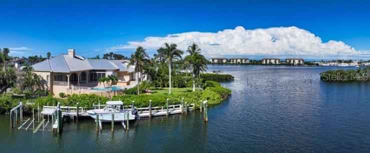 Spectacular Waterfront Estate in Bay Isles | Longboat Key Rarely does a property of this caliber come to market. Located behind the exclusive, 24-hour guarded gates of the Longboat Key Club in the prestigious Bay Isles community, this estate spans 4,200 square feet of elegant one level living space. With 5 spacious bedrooms, 4.5 baths, plus a dedicated office—all under soaring 12-foot ceilings—this home offers refined luxury with an unmatched sense of openness and light. Set on one of the largest lots in Bay Isles at just under 20,000 square feet, this peninsula-shaped property boasts 205 feet of prime water frontage and breathtaking, unobstructed views over Buttonwood Harbor. Enjoy the ultimate boating lifestyle with three boat lifts situated along a deep-water, wide canal on the protected north side of the property. Built with solid block construction, the home sits high and dry with an impressive 4,000-square-foot elevated lower level—ideal for the serious car collector, with the capacity to accommodate over 10 vehicles. Currently utilized as a high-end fitness facility, this space offers endless flexibility. The recently updated chef’s kitchen is a dream for culinary enthusiasts, featuring top-of-the-line gourmet appliances, a massive center island, and rich solid wood cabinetry. Outdoors, the magic truly begins—an expansive terrace surrounds the oversized pool, perfectly positioned to take in panoramic views of the harbor. Entertain effortlessly with a outdoor kitchen and multiple lounging areas that make the most of this remarkable waterfront setting. Additional recent upgrades include a brand-new standing seam metal roof (2024), ensuring peace of mind and long-term durability. Residents of Bay Isles enjoy exclusive access to the private Bay Isles Beach Club and its pristine Gulf-front beach, as well as the convenience of on-site amenities including Publix, CVS, banking, dry cleaning, and more. This is more than a home—it’s a once-in-a-lifetime opportunity to own one of the most coveted properties in Bay Isles. Don’t miss your chance to make this exceptional estate your own.