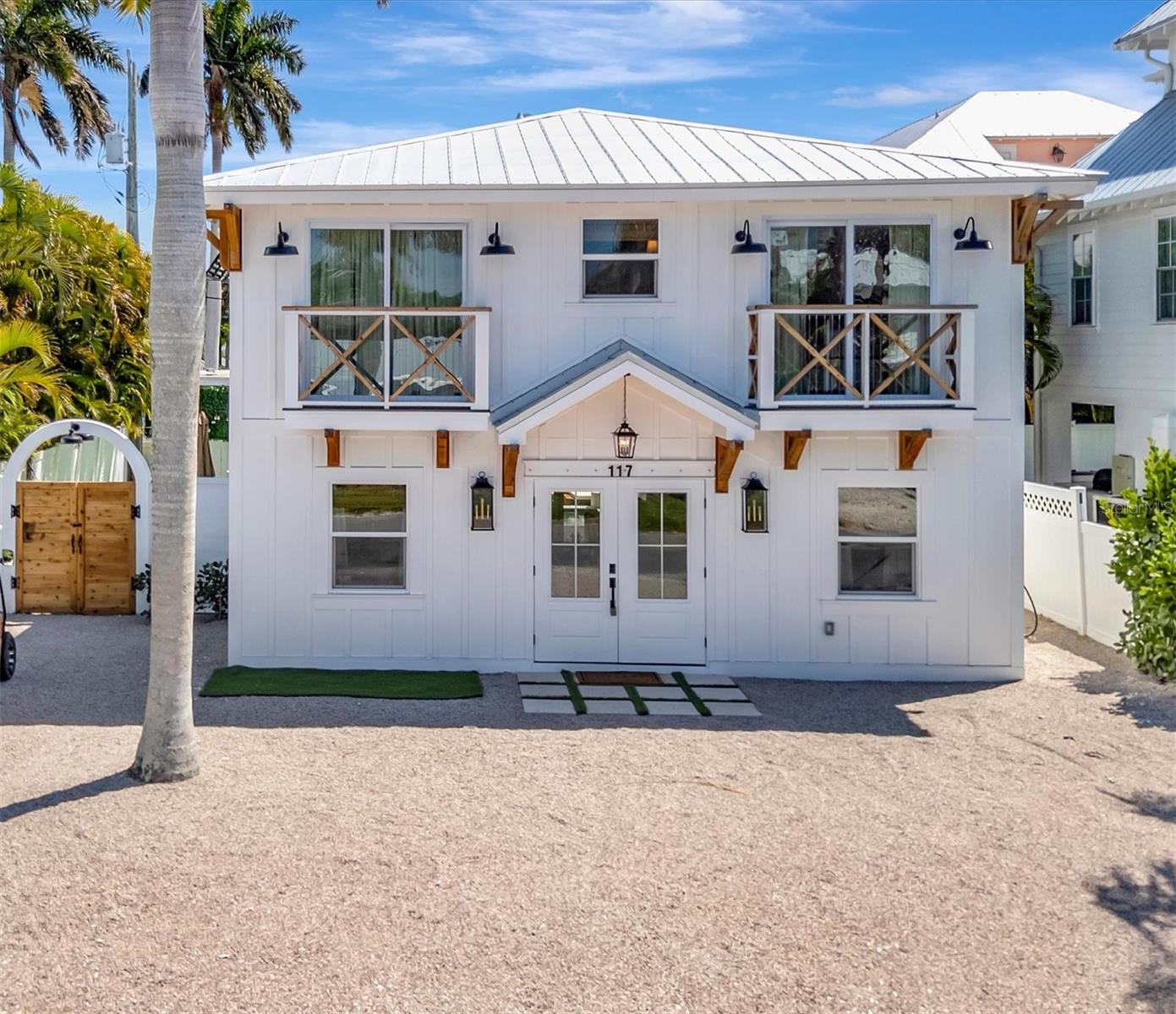 Welcome to 117 81st Street in Holmes Beach, a custom-designed coastal retreat steps to the beach that has been completely renovated inside and out, offering the perfect blend of modern luxury and effortless island living. This beautifully updated 4-bedroom, 3.5-bath home is being sold turnkey furnished, making it move-in ready or immediately available as a high-performing rental investment. The first-floor open layout is designed for both entertaining and everyday comfort, featuring a spacious living area that flows seamlessly into the gourmet kitchen and dining space. The kitchen is a true centerpiece of the home, showcasing a large island with custom concrete countertops, distinctive range accents, and ample space for gathering. Adjacent to the kitchen, the dining room features a built-in bar with open shelving, creating the perfect setting for hosting guests or enjoying relaxed island evenings. A conveniently located half bath is also situated on the main living level. All four bedrooms are located on the upper level, offering privacy and a well-designed layout for families and guests. The spacious primary suite serves as a relaxing retreat and features a beautifully designed bathroom with an oversized walk-in shower. A fun and functional bunk room with its own en suite bathroom provides the perfect space for kids or visiting guests, while two additional bedrooms share a Jack-and-Jill bathroom, creating a comfortable and efficient layout for larger groups. Step outside to your private backyard oasis featuring a brand-new heated pool and spa, a covered patio with warm wood ceilings, outdoor grill area, multiple lounge spaces, and two inviting fire pits—perfect for entertaining or unwinding after a day at the beach. Additional upgrades include a brand-new metal roof, along with extensive renovations throughout the home that make this property feel completely refreshed and modern. Located just steps from the white sand beaches of Anna Maria Island, the home is also conveniently close to the island’s best restaurants, shops, and local attractions. Whether you’re looking for a high-revenue producing short-term rental, a primary residence, or a private Florida retreat, this exceptional property offers incredible versatility in one of the island’s most desirable locations.