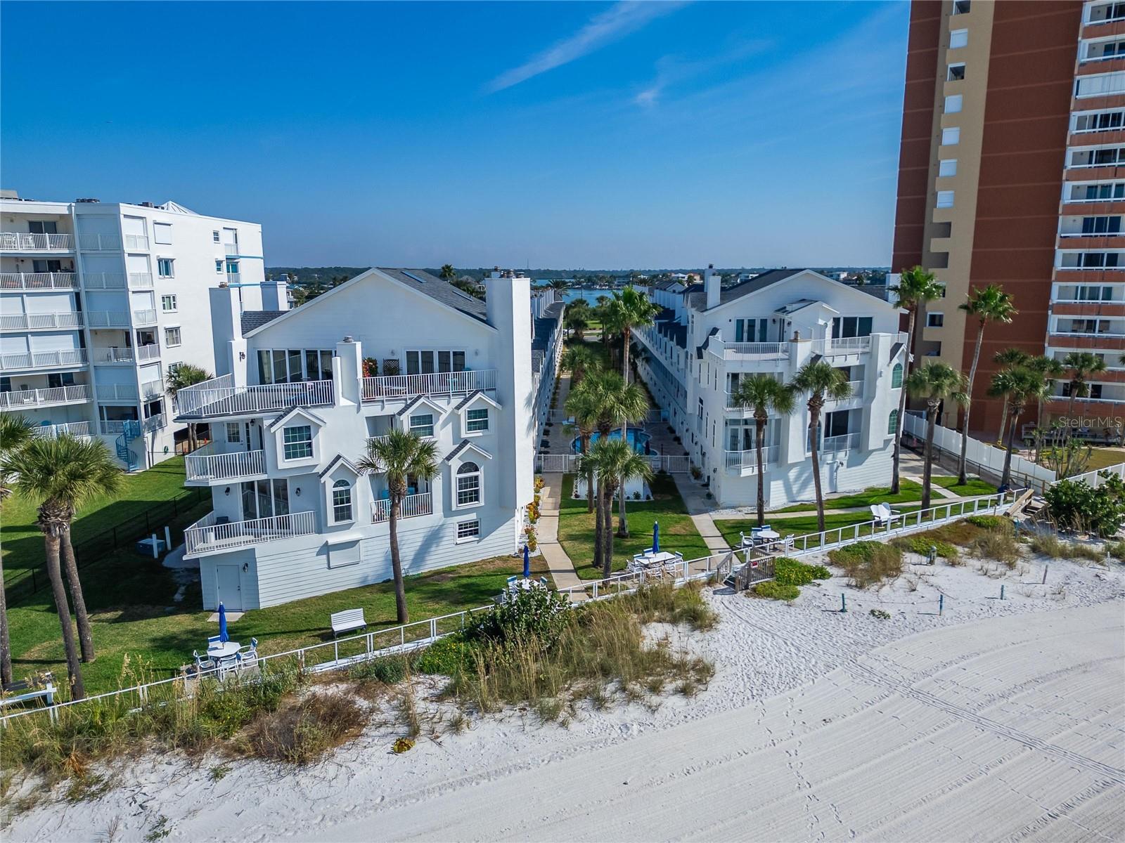 Welcome to Sunset Reef, a charming coastal community in beautiful Redington Shores! This stunning beachfront townhome offers the perfect blend of luxury and comfort, featuring 3 bedrooms, 1.5 bathrooms, a 1 attached tuck-under garage with both guest and assigned parking spots. This unit has three levels, including the garage. All three bedrooms are on one level, upstairs above the living room. The master bedroom features generous closet space, a private balcony, and is connected to a full bathroom. The second bedroom has partial views capturing both the gulf and intercoastal. The third bedroom is furnished with a bunk bed and features a raised ceiling and skylight. On the main level, you will find a fully equipped kitchen with stainless steel appliances and a granite countertop. The main level features a breakfast nook, in-unit laundry, a bathroom, dining area, living room, wood-burning fireplace, and another private balcony. The HOA covers Cable TV, Internet, Insurance, Water, Sewer, and Trash, making ownership simple and worry-free. Perfect for vacations, full-time living, or as a lucrative investment this can be your piece or paradise. Just a short drive away, you’ll find John’s Pass Village & Boardwalk, Pinellas County’s #1 tourist attraction. This lively waterfront destination features over 100 shops and restaurants, dolphin-watching cruises, fishing charters, boat and jet ski rentals, parasailing, and a vibrant boardwalk perfect for strolling and enjoying the views.
