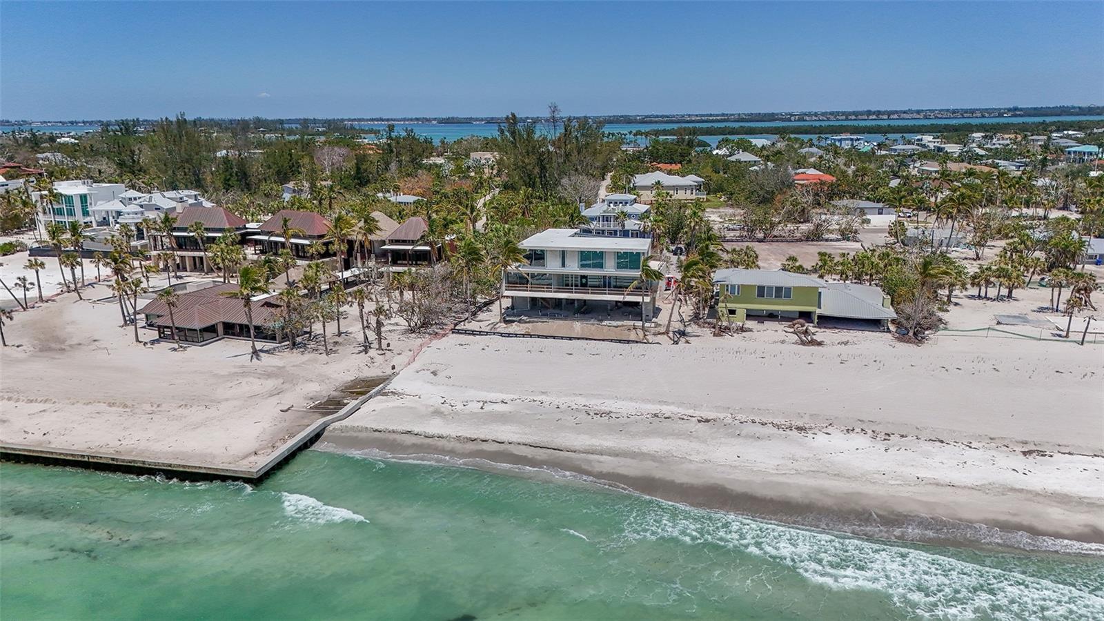 Discover an extraordinary opportunity to own two parcels in a newly developed beachfront enclave, complete with private entry gates  when project is complete leading directly to the pristine sugar sands and turquoise waters of the Gulf of Mexico. Parcel one, identified by property ID 7847700154, offers a 2,000-square-foot homesite with 100 feet of direct Gulf frontage. Parcel two, property ID 78477000078, is a sprawling 9,757-square-foot parcel. These two exclusive Gulf-front estates are nestled at the end of North Gulfside Road on Longboat Key, offering unmatched privacy in a secluded cul-de-sac. With endless views, serene surroundings, and ultimate exclusivity, this is a rare chance to create your dream coastal haven. 6509 is also listed if you would like to have a estate size lot.