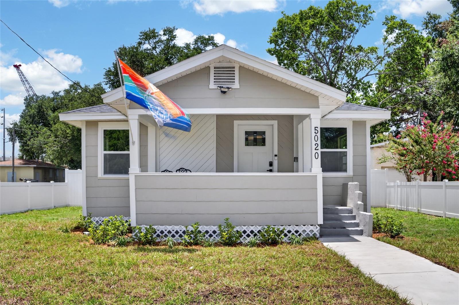 Virtually Staged. 5020 22nd St N, St. Petersburg, FL 33714 - Completely Renovated Bungalow with Detached Garage, Alley Access & Modern Upgrades!
Welcome to this beautifully remodeled St. Petersburg bungalow, where timeless charm meets modern convenience. Perfectly situated in a centrally located neighborhood just minutes from Downtown St. Petersburg, I-275, restaurants, shopping, parks, and the Gulf beaches, this move-in ready home offers everything today's buyers are looking for. This thoughtfully updated 2-bedroom, 2-bathroom home features an open and inviting floor plan with luxury vinyl plank flooring, fresh Sherwin-Williams designer paint, updated lighting, new baseboards, and abundant natural light throughout. The stunning kitchen is designed to impress with white shaker cabinetry, granite countertops, subway tile backsplash, stainless steel appliances, and plenty of cabinet space—perfect for entertaining or everyday living. Major system updates provide peace of mind and include: New roof, Updated plumbing, Updated electrical, Tankless water heater, Newly blown attic insulation, New interior and exterior doors.  Step outside to enjoy the welcoming front porch, fresh landscaping, new sod, and a fully fenced backyard with a new PVC privacy fence, creating the perfect outdoor space for pets, family gatherings, or relaxing evenings. One of this property's standout features is the detached accessory garage with alley access, offering endless possibilities. Whether you're looking for a workshop, home gym, hobby space, secure parking, additional storage, or a home-based business setup, this versatile building delivers. The garage includes a new garage door and opener, while the adjoining laundry area is equipped with its own mini-split air conditioning system for year-round comfort. Additional exterior improvements include enhanced alley access with new City of St. Petersburg alley material, making access to the detached garage even more convenient.