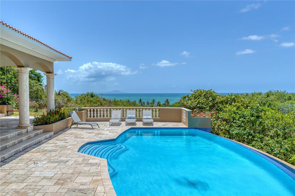 Perched high on the hills of Palmas del Mar with expansive views of the Caribbean Sea and Vieques Island. 9 Shell Castle offers the utmost privacy and seclusion, all within the confines of a gated, amenity-rich, world-class boating resort community.

Custom built in a contemporary Mediterranean style, the residence's gracious 3891 Sq. Ft. layout takes advantage of the striking ocean views throughout. Renovated in 2018, the immaculate interior is highlighted by marble floors, high ceilings, Tuscan-inspired columns and archways, as well as an open concept state-of-the-art kitchen complete with chef-grade stainless steel Thermador appliances. The main level of the home showcases multiple living spaces, dining room and laundry as well as four bedrooms and three full baths. Floor to ceiling glass sliding doors connect the interior to its lavish outdoor entertainment areas and stunning infinity pool, which serves as a gorgeous setting for watching the sunrise near Vieques every morning and gazing at the moon every night as the reflection perfectly aligns with the ocean to create a spectacular display. The lower level features a fifth ensuite bedroom in addition to ample storage areas and accommodating two-car garage.

Offering the ultimate levels of comfort and convenience, Palmas del Mar is internationally renowned for its top golf courses, tennis courts, equestrian center, private school, restaurants, shopping venues and beachfront location on the southeast coast of the island. Only a 40-minute drive away from San Juan, enjoy the pinnacle of resort living while still being in close proximity to the Metropolitan area.

Annual HOA Fee: $900.