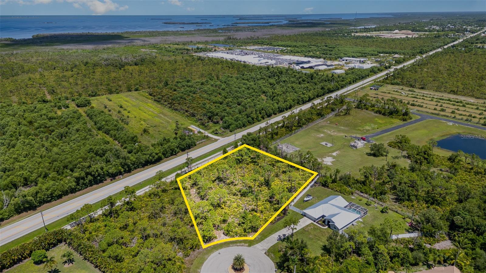 Island Living, Redefined – 1.24 Acres in Island Acres. Discover the rare opportunity to own 1.24 acres inside the private gates of Island Acres, one of Pine Island’s most sought-after communities. With only 31 homesites, this exclusive neighborhood offers the perfect balance of privacy, natural beauty, and modern convenience. At the heart of the community lies Treasure Lake, a sparkling 12-acre centerpiece where residents can enjoy a picnic at the lakeside pavilion, stroll the sandy beach, or simply take in the peaceful water views. Outdoor enthusiasts will love the 1-mile nature trail and jogging path, as well as the dedicated bike path that winds through the neighborhood. Every homesite in Island Acres is equipped with underground utilities and city water, preserving both convenience and curb appeal. Architectural standards ensure a community of high-quality homes, featuring a minimum of 1,700 square feet of living space, allowing you the freedom to design a custom residence that suits your lifestyle. Island Acres offers more than just a lot—it offers a vision: a gated retreat close to shopping, schools, and the charming waterfront culture of St. James City. Here, you can create your dream home and become part of a community where nature, privacy, and comfort come together seamlessly.