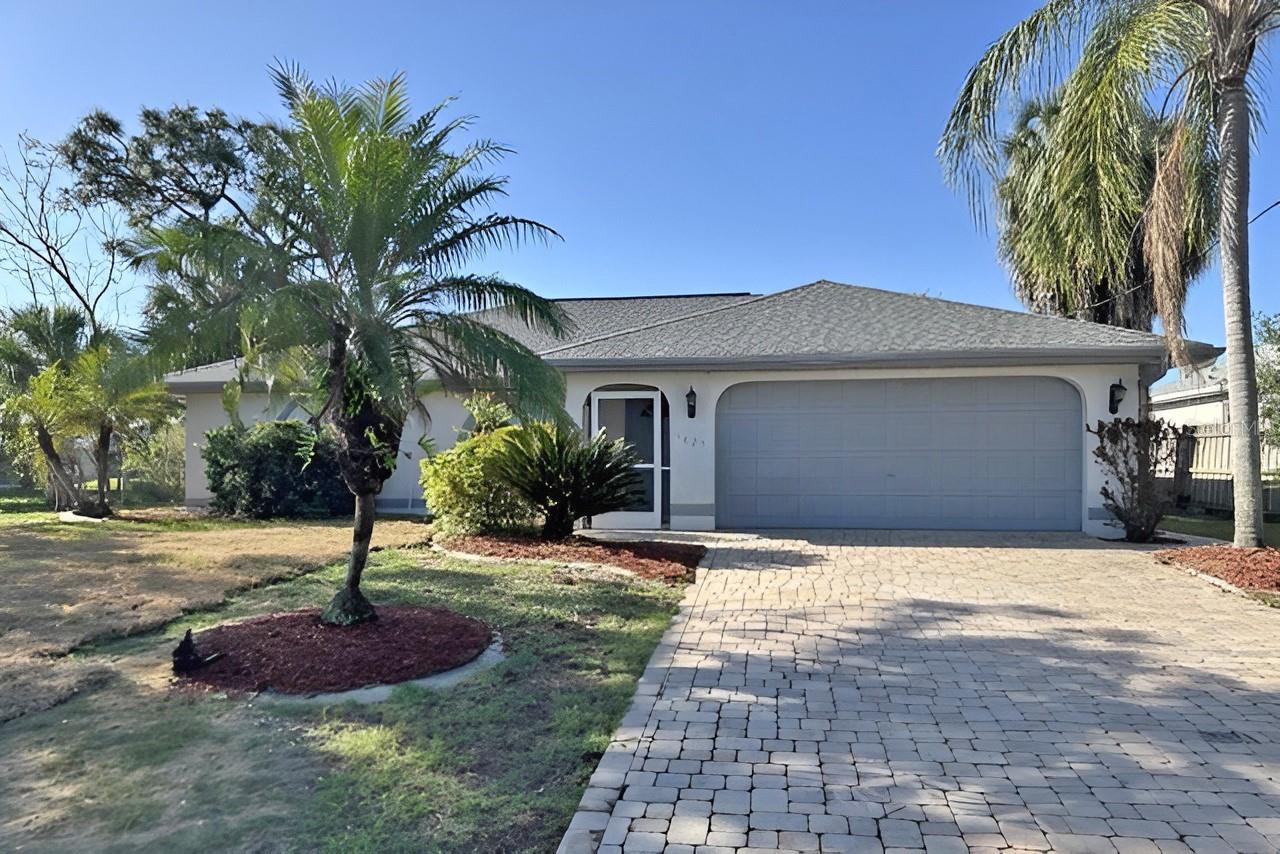 This home features three bedrooms and two bathrooms, providing comfortable accommodations for daily living. The thoughtful configuration offers practical space for various needs and activities.  You'll enjoy the peace of mind with new septic, HVAC system, updated irrigation and fresh interior paint. The dual bathroom setup ensures convenience during busy morning routines, while the three bedrooms are split with the two guest rooms on opposite side of home from primary, providing flexibility for sleeping arrangements. All bedrooms have walk in closets, providing extra storage.  Tile throughout the property with exception of carpet in primary suite, deliver durability and easy maintenance. This consistent material choice creates a cohesive aesthetic while offering practical benefits. Curb appeal complemented is complemented with the  paver drive and walkway to front entry.  This is a home that is designed for comfortable daily life.  Call today to schedule a viewing and experience firsthand all the comfort and convenience this property has to offer in this lovely location.