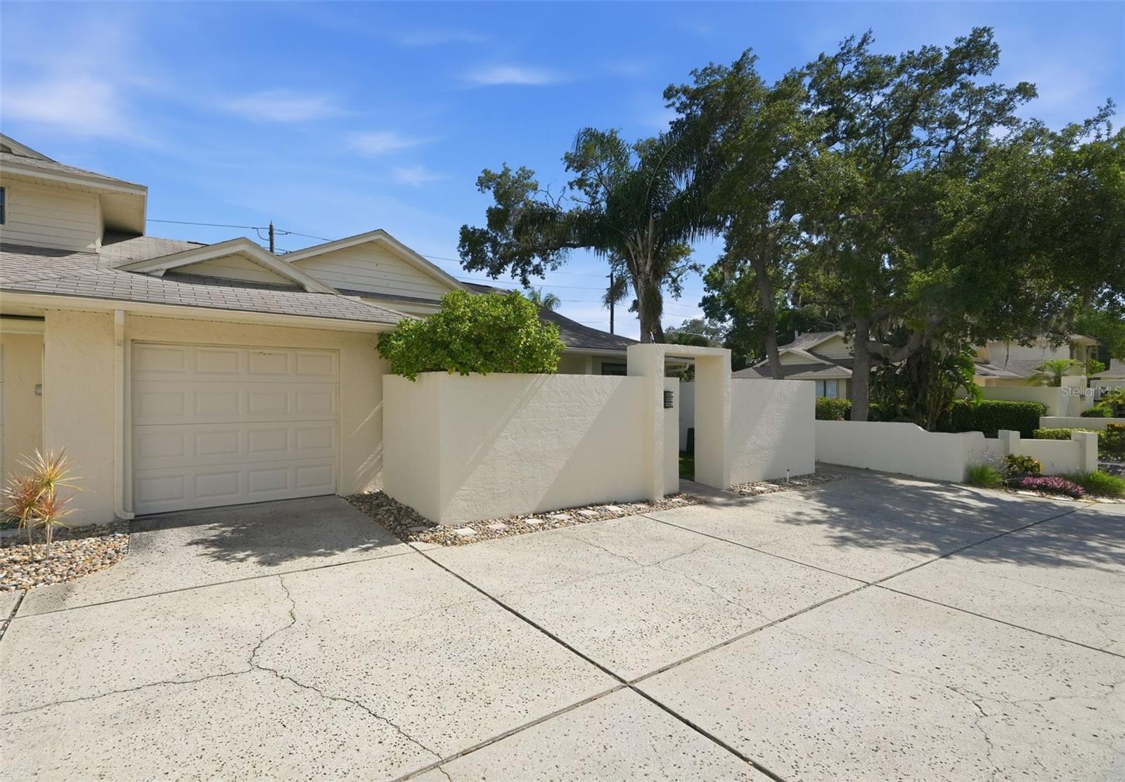 Welcome to this beautifully updated 2 bedroom + office/den, 2 bathroom villa in Tarpon Springs featuring a 1 car garage and your very own private pool. FULLY RENOVATED FROM TOP TO BOTTOM, INSIDE AND OUT IN 2023, truly a rare find! Inside, you’ll love the fully renovated kitchen featuring a massive kitchen island with waterfall edge, oversized sink, stainless steel range hood, 2023 stainless steel appliances, and stunning Cambria Britannica Gold Warm Quartz Countertops. Just off the kitchen is a matching bar area with mini fridge that is the perfect space for entertaining. Open floor plan with 2023 luxury vinyl plank flooring throughout the entire home (NO CARPET!). The office/den could easily be used as a 3rd Bedroom. This home has its own 1 car garage and a generously sized laundry room with built in shelving and cabinets. Additional interior upgrades include fully remodeled bathrooms, solid-core interior doors, updated LED lighting, and modern ceiling fans (all 2023). Step outside to your screened patio and enjoy your newly pavered pool deck surrounding the private SALTWATER POOL, resurfaced in 2023 with PebbleTec and equipped with a SOLAR HEATER for year round enjoyment. The pool deck even faces south so you will never have to chase the sun in the winter months! Additional improvements include a pavered entryway, new garage door (2023), and updated interior and exterior paint. To top it off, the wall mounted 75” QLED living room TV and mounted patio TV comes with the home. Located less than 1 mile to Sunset Beach, 2 miles to Howard Park, and just 3 miles to the world famous Sponge Docks, you’ll enjoy the sunshine and easy access to waterfront dining, shopping, and entertainment. Historic Downtown Tarpon Springs and Innisbrook Golf Resort are also just minutes away. Move right in and start enjoying the Florida lifestyle!