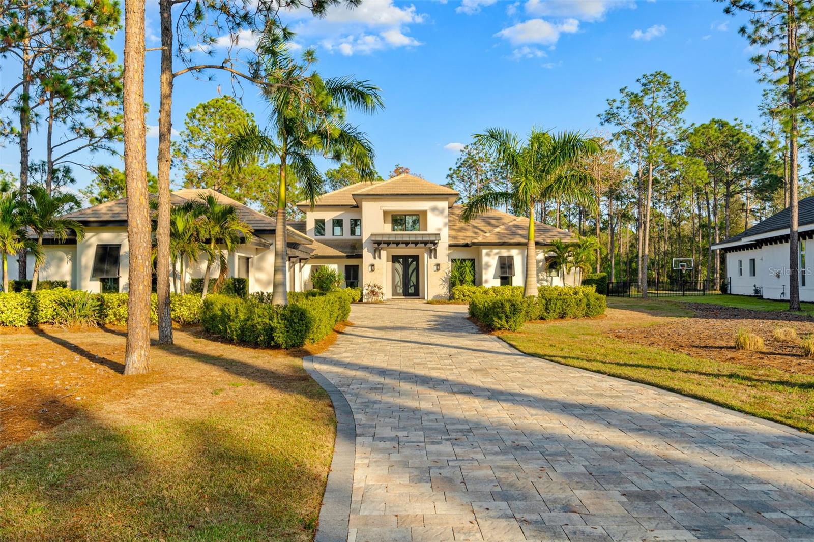 One or more photo(s) has been virtually staged. Welcome to Villa del Mar – a breathtaking custom masterpiece by J. Drewes, nestled in the heart of Bella Collina, Central Florida’s most exclusive luxury community. Spanning 1.28 acres of pristine preserve land, this estate seamlessly blends elegance with nature, offering an unparalleled indoor-outdoor living experience.
Step through the grand custom double doors and into a world of sophistication. The soaring 23-foot atrium great roomstuns with tongue-and-groove ceilings, rich wood beams, engineered hardwood floors, and a striking brick fireplace—a space designed to impress and invite.
Culinary enthusiasts will delight in the gourmet chef’s kitchen, where 3-inch Quartz countertops, custom wood cabinetry, and top-of-the-line Sub-Zero & Wolf appliances create the perfect backdrop for both intimate meals and grand entertaining. A large walk-in pantry, dry bar, Wolf espresso machine, and bar fridge elevate every culinary moment.
The primary suite is a sanctuary of tranquility, offering private pool access, a stunning preserve-view picture window, a spa-inspired ensuite with a soaking tub, double vanity, and an expansive walk-in shower. Thoughtfully designed as a 5-bedroom estate with a separate casita, the home is currently configured as 4 bedrooms, an office, and a casita—a space that adapts effortlessly to your lifestyle, whether as a guest retreat, art studio, or personal haven.
Step outside and experience Florida living at its finest. The outdoor oasis boasts a summer kitchen, fireplace, and retractable electric screens, all leading to the resort-style pool and swim spa—a private retreat that invites relaxation and entertainment alike.
Additional luxuries include a 4-car garage, a state-of-the-art smart home system, and a stylishly designed laundry and mudroom.
Living in Bella Collina means access to a world-class Sir Nick Faldo-designed golf course, scenic walking trails, a resort-style pool, a full-service spa, fitness center, fishing, Har-Tru tennis and pickleball courts, and two exclusive clubhouse restaurants. Just minutes from Montverde Academy, the West Orange Trail, charming Downtown Winter Garden, and Clermont’s vibrant lake life, and within an hour of Florida’s stunning beaches—this is more than a home; it’s a lifestyle.
Experience the pinnacle of luxury living. Schedule your private tour today!