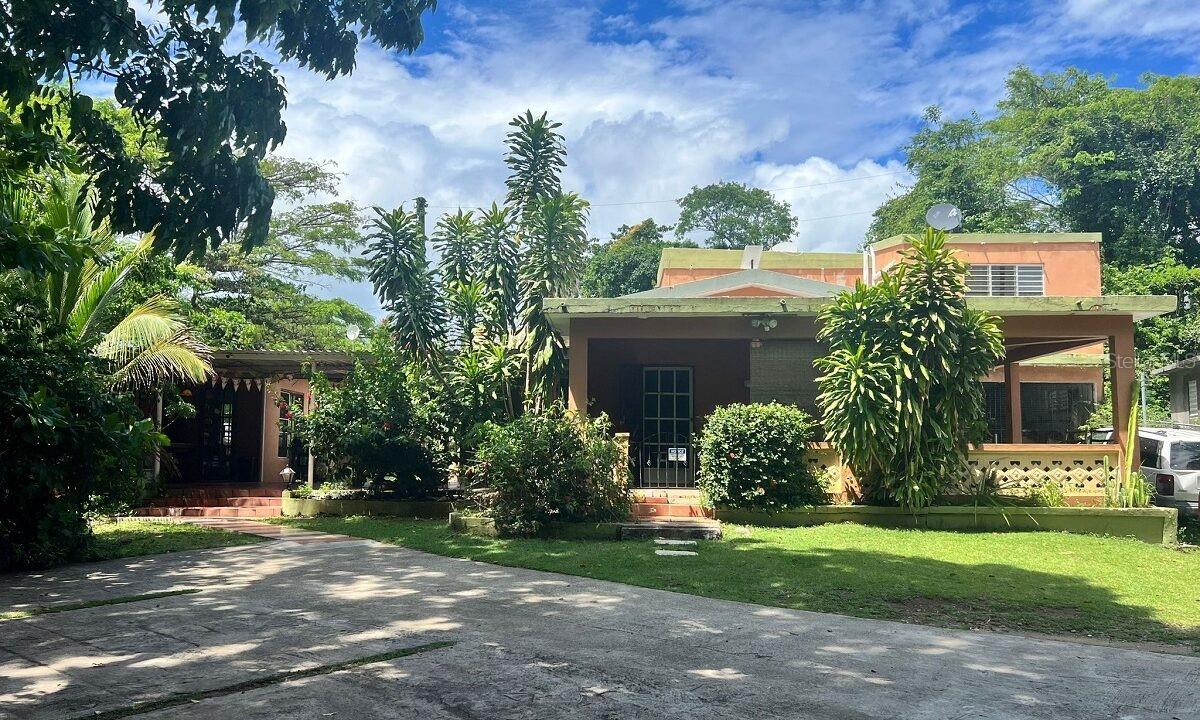 Welcome to Isla Hermosa guesthouse, tucked away in the tranquil, idyllic neighborhood of Destino.  This income producing, fully permitted business is an opportunity hard to find! You won't want to leave this peaceful setting in paradise.

There are a total of 6 bedrooms, 7 bathrooms, a sun room, garage, storage area, extra outdoor shower space, and outdoor kitchen, living space.  Spanish style tile throughout. The owners living area is large, comfortable 2 bedroom, 2 bathroom with a full updated kitchen. The four rooms upstairs are rented out year round. Three of the rooms have a queen bed. The fourth room, (the suite), has a king, a futon and a full bed, able to sleep 5!!  It also boasts a beautiful private balcony that you can step out to from the living space to relax and enjoy the view. All the rooms upstairs have new AC units, coffee makers, hairdryers, and lovely personal touches to make a person feel at home and comfortable. Ocean views from the upper roof, so many possibilities!! Two washers and dryer. Security cameras in place, and starlink internet, grid tied solar for a seamless transition so you dont have to worry about power outages! Being located on a dead end road, of course means very little traffic and the serenity that comes with it.

Downstairs there is a covered outdoor kitchen and living space. Being able to cook and enjoy the outdoors in the Caribbean is and experience not to be forgotten. The sun room is such a unique space with warm wood ceiling and accents, windows on every side, making it feel open, alive and vibrant.  It has a pool table, dart board, bathroom, and comfortable seating. Guests can use this area to play games, relax, mingle and more. If desired this area could be turned into another rental. Just outside the sunroom is an outdoor shower to keep things clean when coming in from the beach!

Set on approximately 2 beautiful fenced, groomed acres with abundant fruit trees including coconut, starfruit, mango, sweet almond, guayaba, and mature bamboo. Peacocks have always been a part of this property.... There are two cisterns that just need to be hooked up, and a small generator. This is an amazing turnkey opportunity, and there is even more potential if one wanted! A pool could be added, casitas, and so much more to add your personal touch and make your dream come true.