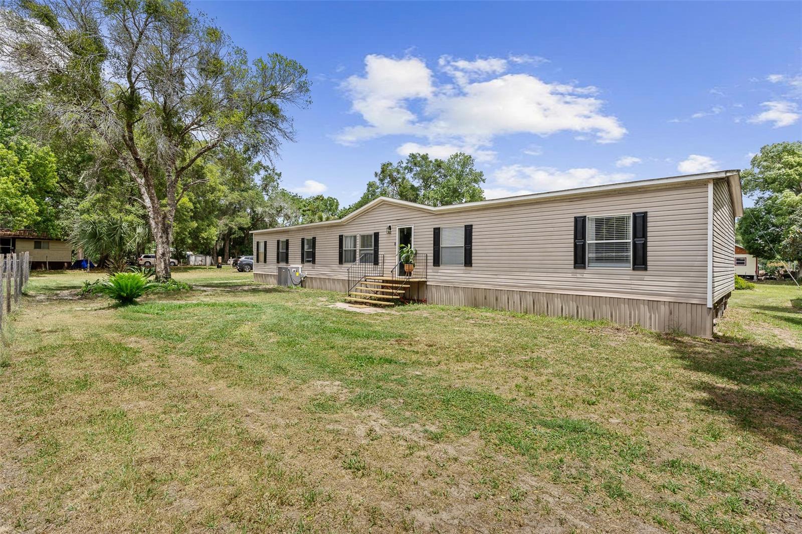 SELLER IS OFFERING CONCESSIONS- Spacious and beautifully updated manufactured home situated on over 0.70 acres, including an adjacent lot that offers endless possibilities. Whether you’re seeking extra privacy, space for recreational vehicles, a future workshop, pool, garden, or even a potential build opportunity, this property provides exceptional flexibility and value. Inside, you’ll find a bright, open layout featuring updated flooring, modern finishes, and generously sized bedrooms. The functional kitchen is perfect for both everyday living and entertaining. The oversized primary suite offers incredible versatility and could easily be partitioned to create a home office, nursery, or additional flex space. The AC is a year old.

Step outside to enjoy a large yard with plenty of room to roam, relax, and embrace peaceful Florida living. The property is equipped with two wells and a septic system, helping to keep utility costs lower.
Conveniently located just minutes from shopping, dining, hospitals, and medical facilities, you’ll also be close to popular destinations such as Salt Springs, Silver Glen, Green Cove Springs, Keystone Heights, and Fort McCoy. Within an hour, you can reach Crescent Beach, historic St. Augustine, Flagler Beach, Palm Coast, Gainesville, and Ocala. World-famous Daytona Beach, Orlando theme parks, and Jacksonville are all within a two-hour drive. This is a rare opportunity to own space, land, and move-in-ready comfort.

County lot inquiry completed. Adjacent Parcel confirmed as a legal lot of record and eligible for one single-family residence. AG zoning permits mobile homes. Future lot split may be possible if community water/sewer becomes available. Buyers to verify all intended uses, septic, and permitting with Putnam County.