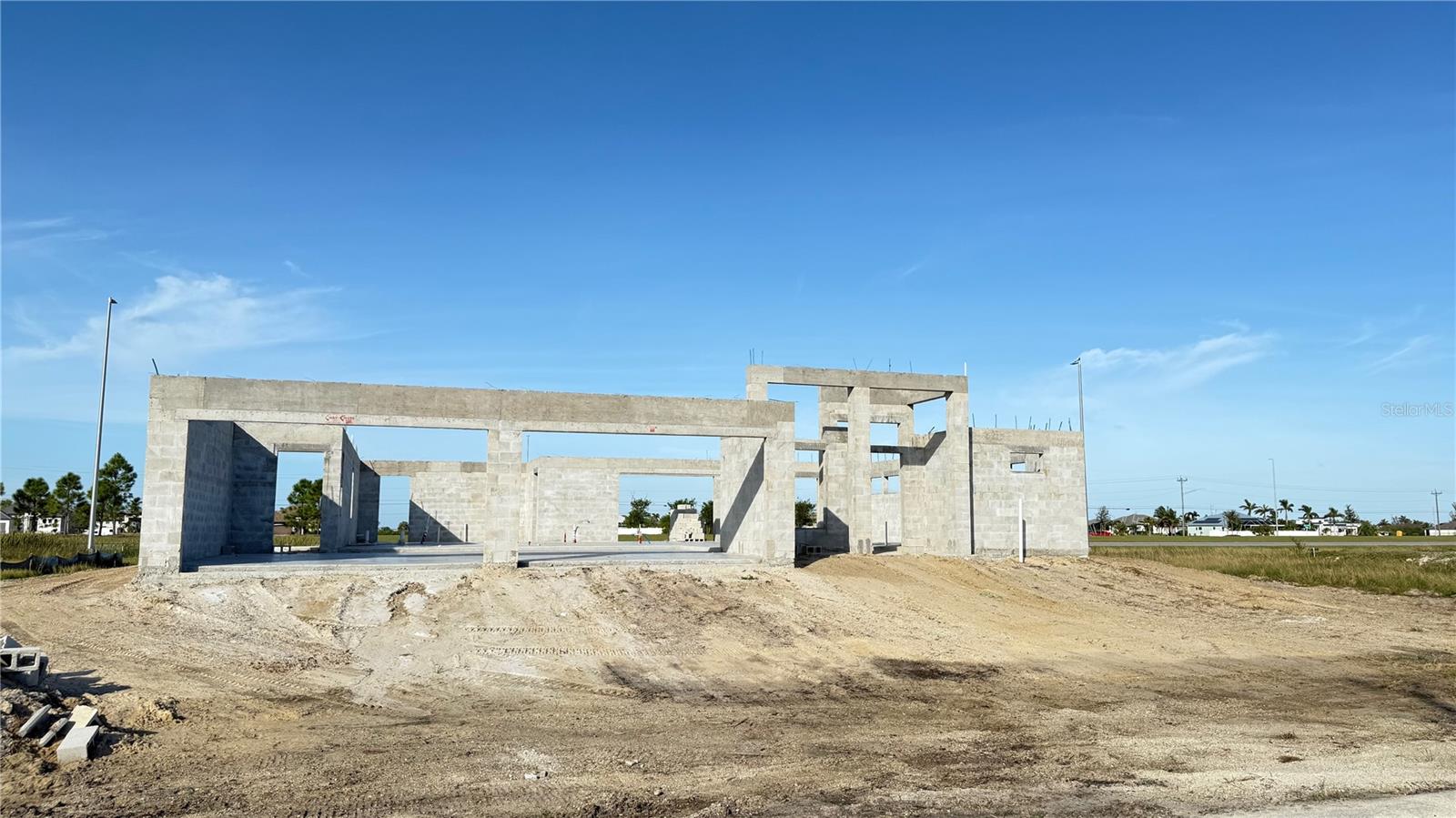 Under Construction. New price. Lower basis. Finish the project your way. Strategically repositioned at $267,300, this as-is, mid-construction Orlando II model in NW Cape Coral offers a compelling opportunity for builders, investors, and hands-on owner-users comfortable completing construction. Planned for approximately 2,590 sq ft of living area and 3,856 sq ft total, the home includes 3 bedrooms plus a den, 3 baths, and a 4-car attached garage, with slab and concrete block work already complete. The current stage of construction gives the next buyer a defined starting point while preserving control over remaining finishes, selections, and completion strategy. The oversized six-lot site totals approximately 0.70 acres, with approximate dimensions of 245 x 125, and may offer flexibility to retain as a larger estate-style homesite or split into two triple-lot parcels, subject to City of Cape Coral approval. Preliminary plans also include a detached garage concept. No HOA. Well and septic required. Buyer assumes all completion, permitting, utility, and due diligence responsibilities. Available individually or as part of a two-property portfolio with companion listing MLS #C7520222. Construction documents, plans, and permit details are available upon request.