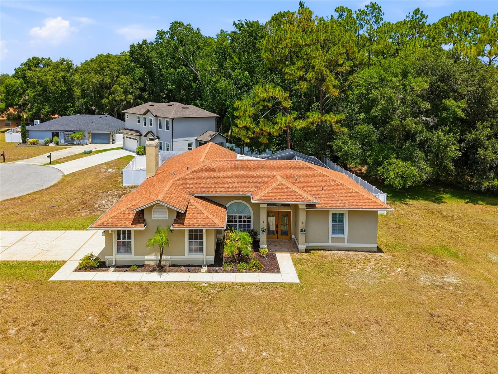 If you're looking to get away from the hustle and bustle while enjoying the beauty of nature, this home is for you. Nestled in the desirable Eagle Island Estates community, you may wake up to deer grazing in your front yard or spot wildlife as you make your way home each day. This beautiful 3-bedroom, 2-bath pool home is situated on a double corner lot and features a side-entry garage located on a quiet cul-de-sac, providing added privacy and curb appeal. Updated vinyl plank flooring flows throughout the kitchen, great room, guest bedrooms, and laundry room. The split-bedroom floor plan offers both privacy and functionality. The beautifully updated kitchen features quartz countertops, soft-close cabinets and drawers, ample storage, walk-in pantry, a breakfast nook, and a breakfast bar, making it the perfect place to gather with family and friends. Just off the breakfast nook, sliding glass doors lead directly to the pool area, creating a seamless connection between indoor and outdoor living. Overlooking the kitchen is the spacious great room, featuring a cozy wood-burning fireplace and plenty of room for entertaining or relaxing with family. The primary suite is privately situated toward the front of the home and features a spacious walk-in closet with built-in shelving. The primary bath offers a walk-in shower, jetted garden tub, and dual vanity sinks. Sliding glass doors from the primary bedroom provide direct access to the pool area, creating the perfect retreat for enjoying your morning coffee or unwinding at the end of the day. Just off the primary suite, you'll find the formal dining room and formal living room. The formal living area features sliding glass doors leading to the pool area, providing another wonderful space to enjoy the outdoor setting and making entertaining guests a breeze. Just beyond the great room, you'll find a spacious inside laundry room featuring vinyl plank flooring, a utility sink, washer and dryer, additional storage space, and convenient access to the side-entry garage. On the opposite side of the home are two generously sized guest bedrooms featuring vinyl plank flooring and an updated guest bathroom. Recent improvements include a brand-new AC unit, a new hot water heater, and new screens on the pool enclosure, giving you added peace of mind. Step outside and enjoy your private screened pool area, perfect for relaxing or entertaining. The pool enclosure features a covered sitting area where you can unwind while overlooking your backyard oasis. The backyard also features vinyl privacy fencing, a storage shed, and a rock parking area accessible through a double gate, providing plenty of room for additional vehicles, a boat, or other recreational equipment. Adding to the privacy, the home backs to a conservation area, and the property next door is owned by the HOA and is used as a common area, offering additional space and seclusion. Conveniently located near restaurants, county parks, the library, and Publix, this home is also just a short drive to Tampa Premium Outlets and The Shops at Wiregrass. An elementary school and middle school are located just down the street, making this an ideal location for a variety of lifestyles. Come experience the peaceful setting, abundant wildlife, and exceptional features this Eagle Island Estates home has to offer. From the double corner lot and private pool to the conservation views and thoughtful updates throughout, this home truly offers the best of Florida living.