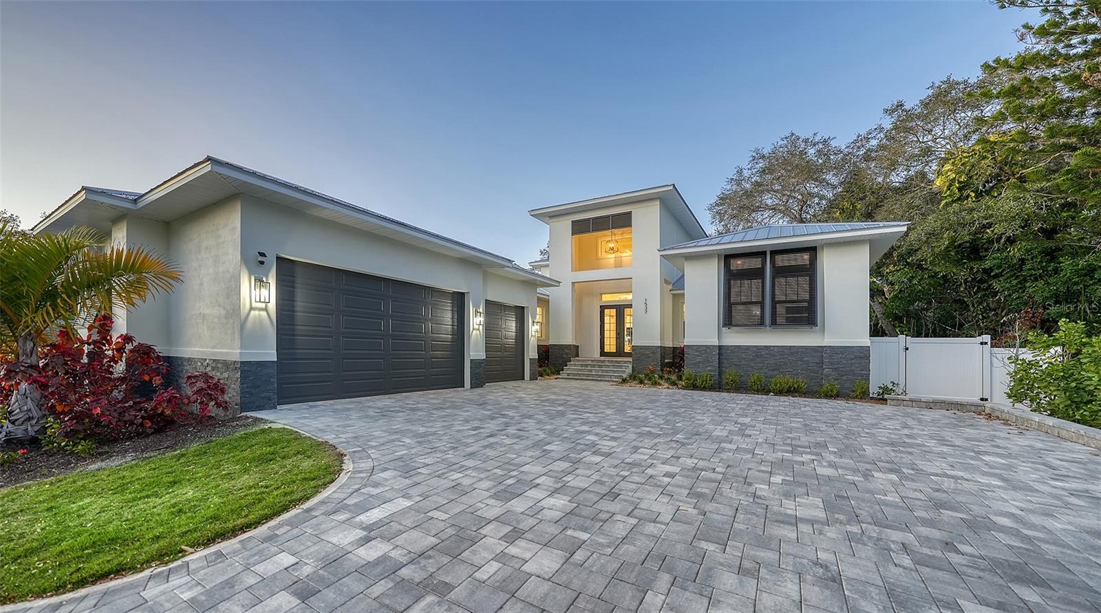 Welcome to 1537 Siesta Drive—an exceptional custom coastal contemporary residence ideally positioned between Downtown Sarasota and world-renowned Siesta Key Beach. Built in 2023, this stunning luxury home offers 4 bedrooms, 4 full baths, 2 half baths, a dedicated office, and over 3,700 square feet of thoughtfully designed living space.
From the moment you enter, you’re greeted by soaring ceilings, rich hardwood flooring, and an open-concept floor plan flooded with natural light. The chef’s kitchen is a showpiece, featuring premium appliances, designer finishes, a wine refrigerator, and seamless flow into the expansive great room—perfect for both entertaining and everyday living.
The first-floor primary suite is a private retreat, complete with spa-inspired bath, oversized walk-in closet, and outdoor access. Upstairs, additional ensuite bedrooms and private balconies offer elevated comfort with peekaboo Sarasota Bay views.
Step outside to your resort-style backyard oasis featuring a heated saltwater pool, outdoor kitchen, putting green, expansive covered lanai for dining and lounging, and lush tropical landscaping—all designed for effortless Florida living.
Additional highlights include a 3-car garage, metal roof, impact windows/doors, and a premier West of Trail location just minutes from Southside Village, downtown dining, marinas, and the beaches. Located within city limits, this home has operated as a successful short and long-term rental.  Financials are available upon request.
Luxury, location, and lifestyle converge at this remarkable Sarasota residence.