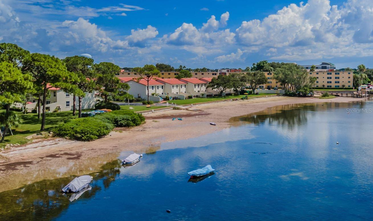 Beachfront living in Dunedin? Surprised? It's right here- feel your mood change watching the sunsets , feeling the fresh Gulf breeze, grabbing your kayak and push off into the water only feet away! Nearly 1600 square feet with a huge patio, 3 bedrooms, 2 1/2 baths, a GARAGE, lots of windows...all in one of Dunedins finest waterfront communities offering its own beach, parks, heated pool, waterfront clubhouse, rec building, fitness center, tennis/pickleball and more! Like convenience? 1-2 block walk to Publix, Walgreens, restaurants- the Pinellas Bike trail across the street and a Golf Course within blocks! The right home at the right price-don't wait to see this one, but if you drive by at dusk you'll fall in love! Room sizes approximate; small pet OK!