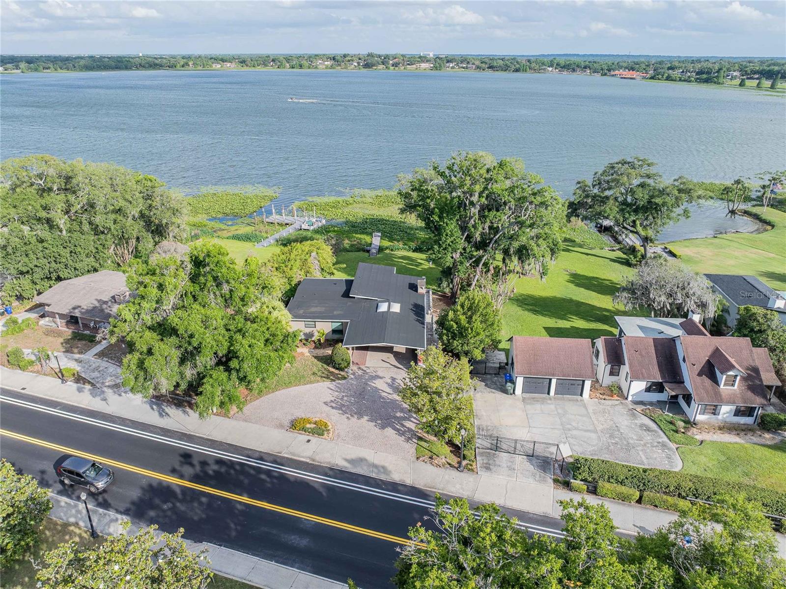 Virtually Staged. Welcome to an exceptional lakefront retreat on highly sought-after Lake Hollingsworth! This beautifully updated 4-bedroom, 3.5-bathroom home blends comfort, style, and breathtaking waterfront living. Thoughtfully improved in 2025 with a new roof, updated electrical and plumbing systems, new gas water heater, the home also features rich hardwood floors throughout, a whole home generator, and two working gas fireplaces.

Designed to capture natural light and stunning views, the upstairs living room, dining room, and sunroom showcase impressive floor-to-ceiling windows overlooking the lake. The sunroom, complete with skylights, is the perfect space to relax or entertain year-round.

The updated kitchen flows seamlessly into the main living areas, while an additional downstairs kitchen and living room provide an ideal setup for guests, extended family, or flexible living arrangements.

The spacious primary suite offers a private balcony overlooking the lake while a versatile bonus room can serve as a fifth bedroom, office, media room, or playroom.

Step outside to a large patio, expansive backyard, and private dock—perfect for boating, fishing, or enjoying peaceful lakefront sunsets.

Don’t miss this rare opportunity to own a stunning waterfront property in one of Lakeland’s most desirable locations!