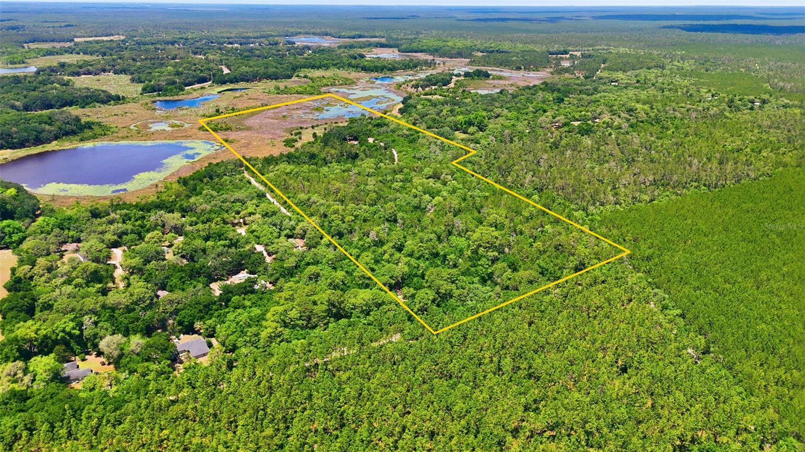 43 ACRES of old Florida on Nicotoon Lake! Endless Possibilities Await YOU! Escape to a peaceful haven at 16050 SE 275th Ave is perfect for outdoor lovers, equestrian enthusiasts, or anyone seeking the tranquility of nature. This sprawling 43.05-acre parcel, measuring 780 x 2662, offers endless opportunities for recreation, boating, fishing, farming, or development.  The property features a 2 Bed 1 Bath cabin that needs TLC. Whether you’re enjoying the serene setting or envisioning the future of this expansive land, this home is your gateway to a new adventure. This land is a dream come true for those looking to build riding trails, ATV trails, or start a farming venture. Nicotoon Lake is a 475 acre lake best known for fishing Bass and Panfish. Best of all, there’s no HOA, allowing you the freedom to create the lifestyle you’ve always imagined. Ready to embark on your next chapter? Schedule your private viewing today and explore the boundless potential of this unique property!