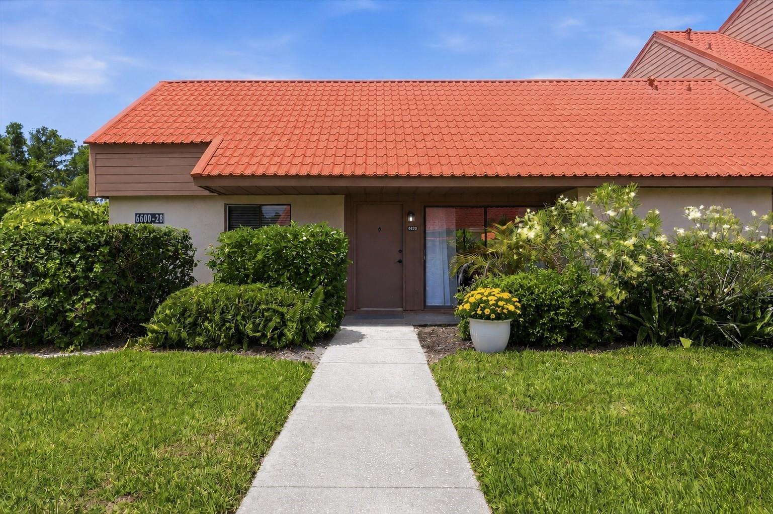 One or more photo(s) has been virtually staged. Enjoy a peaceful setting within Sunrise Golf Club in this THREE BEDROOM END UNIT, offering the ease of single level living with NO RESIDENCE ABOVE. One of the LOWEST HOA FEES in the area for a one level condo. Open concept, split floor plan with primary bedroom including a walk in closet and en suite bath. Living room with vaulted, wood beamed ceilings and dining/kitchen area with stand alone island. Washer and dryer inside unit for added convenience. Large screened lanai for extra space to relax or entertain and for enjoying the Florida weather. This building is in the Phase III section located directly across from the large lake providing water views just outside your door. Deeded carport directly in front with a storage closet for bikes and beach chairs and plenty of nearby guest parking available. Amenities include tennis/pickleball courts, a heated community pool and walking trails. Conveniently located close to plenty of shopping and dining on Clark Rd. Approximately 15 minutes drive to the world famous Siesta Key beach and 20 minutes to downtown Sarasota’s cultural venues, Bayfront park, Selby Gardens, and more dining and shopping options. Schedule your showing today!