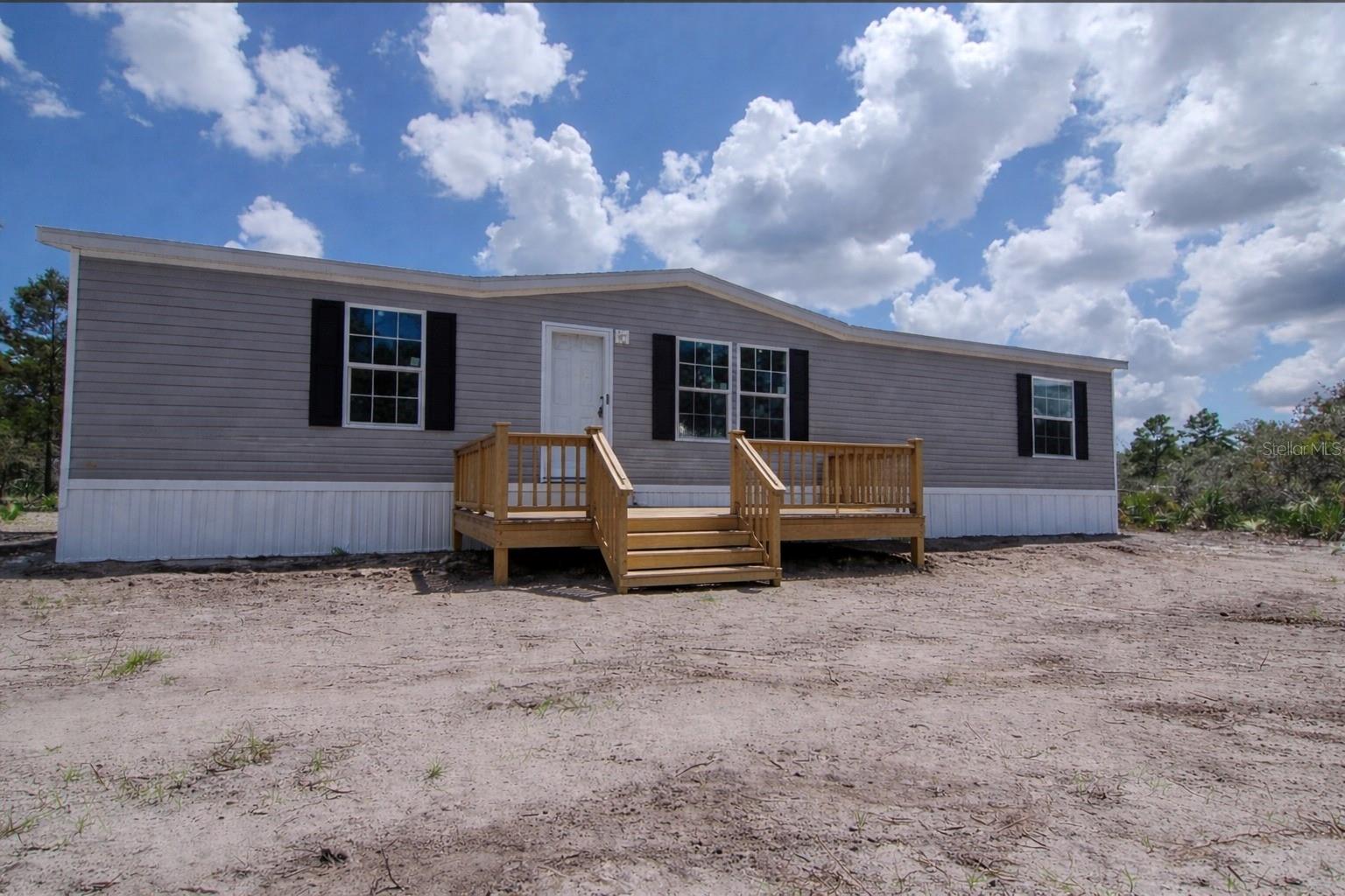Brand New 3BR/2BA Home on 1.25 Acres in the Prairie/Viking area, not far from the paved road, featuring a 1-year manufacturer warranty and seller offering a credit toward buyer’s closing costs with acceptable offer. This beautiful 1,493 SqFt Champion home features a modern split floor plan with warm wood tones and stylish contemporary finishes throughout. The spacious kitchen includes stainless steel appliances and a sliding glass door in the eat-in dining area that leads to the outdoor space, creating easy indoor-outdoor living. A dedicated dining area flows into the inviting living room, creating an open and comfortable space for everyday living. The private primary suite offers a relaxing retreat with a double vanity and well-appointed finishes. Additional highlights include walk-in closets and an interior laundry room. Situated on a 1.25-acre AG-zoned lot, this property provides plenty of room for animals, RVs, boats, or future additions like a barn, garage, workshop, or pool. Home is expected to be completed in approximately 30–60 days.