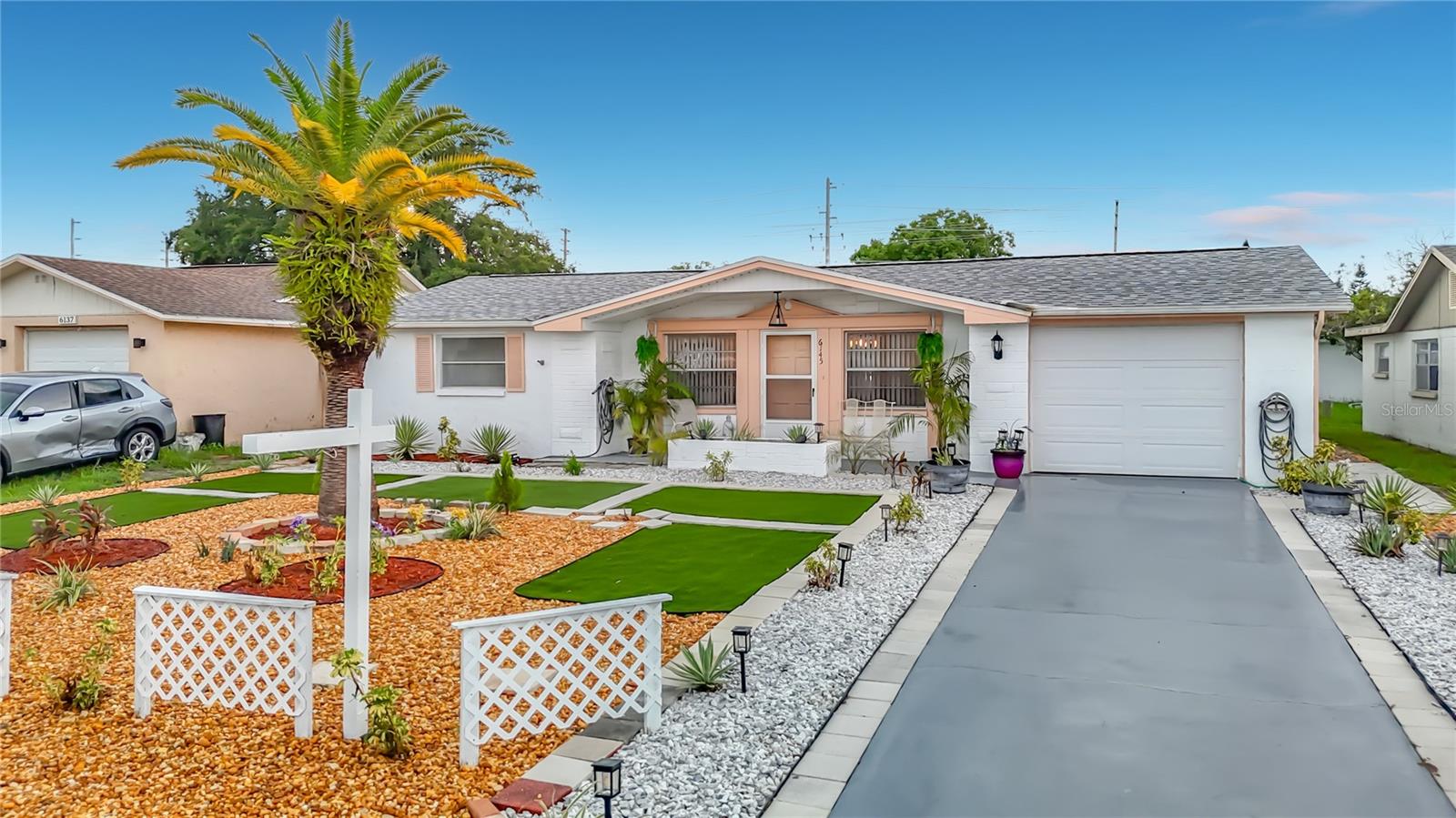 A well-maintained & immaculately clean 2 -bedroom home with 1 full bath plus an additional half bath featuring a toilet and shower. This property delivers comfort, convenience, and peace of mind thanks to major recent upgrades. With ceramic tile flooring throughout, a new roof (Jan 2025), new A/C & heat (May 2024), new appliances (2025) built in oven, stovetop & refrigerator.  An Open floorplan with a great layout.  The Lanai/ Florida room has newer windows, a new garage door (2025), & it's landscaped and backyard is fenced in. The big-ticket items are already taken care of. This location is about 3 miles from downtown Historic New Port Richey which features concerts, events, restaurants, shops, historical sites, & night life. The location is in the heart of shopping, entertainment, restaurants, medical, parks, beaches, and Tampa International Airport is a 40-minute commute. NO HOAS FEES & NO FLOOD INSURANCE REQUIRED! A must see and move in ready!