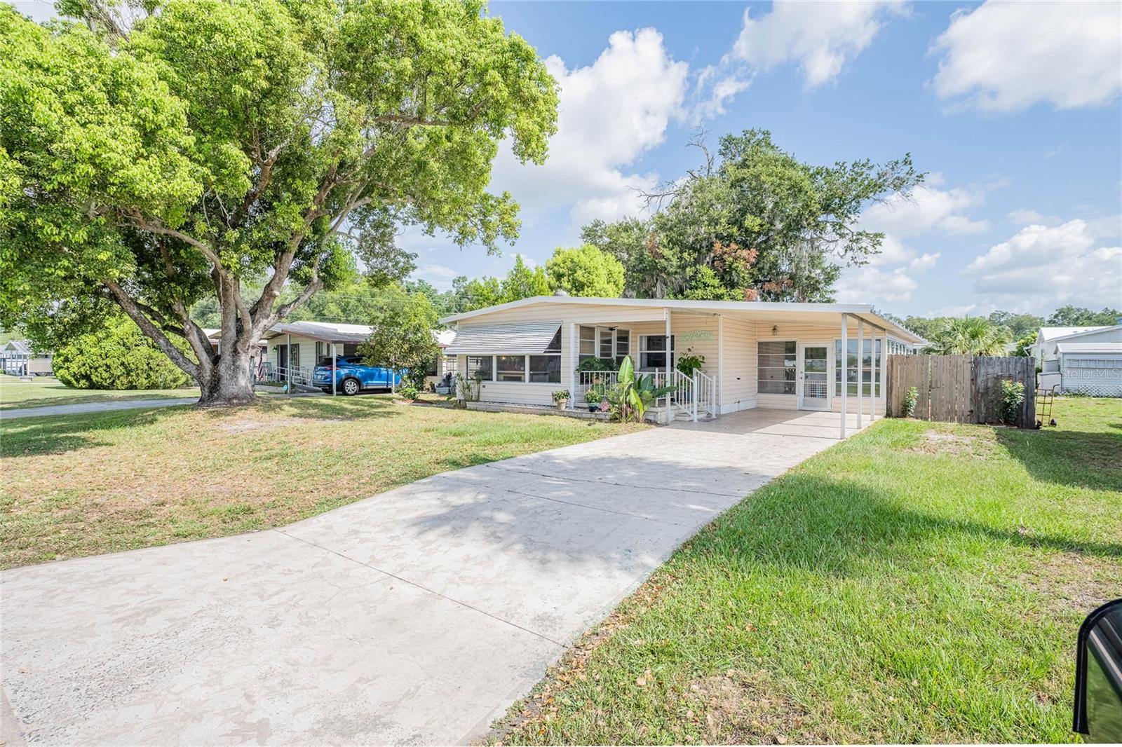 Discover why so many residents love to call Betmar Acres home. This sought-after 55+ community in the heart of Central Florida offers the rare advantage of OWNING THE LAND - NO LOT RENT! ASSUMABLE LOAN AT 3.5% Interest!  Enjoy an active, resort-style experience with an impressive selection of amenities to keep you engaged, connected, and enjoying every day. Beautifully updated, this home offers the perfect blend of style, comfort, and functionality. The light and bright kitchen has been tastefully renovated, featuring quartz countertops, a deep stainless-steel sink, a pull-out spice rack, all-new appliances, new cabinetry, and new flooring, creating a space that's as beautiful as it is practical. Luxury vinyl plank flooring flows throughout the home, complementing the freshly painted interior and giving every room a clean, modern feel. Both bedrooms feature walk-in closets.  Spacious Florida room and vented front sunroom lead out to a covered porch—the perfect spot to enjoy your morning coffee or unwind in the evening. Located in the desirable pet section of Betmar Acres, this home also features a private, fenced backyard, providing a peaceful outdoor retreat for relaxing, entertaining, or letting your furry companions roam safely. Whether you're looking for a seasonal getaway or a full-time Florida residence, this thoughtfully updated home is ready for you to move in and start enjoying the Betmar lifestyle. Enjoy the many amenities that Betmar Acres offers with 27 holes of golf, 2 swimming pools and 2 hot tubs along with 3 clubhouses, a library, walking paths, game rooms (Billiards, Table Tennis, Board Games) miniature golf, enclosed shuffleboard courts, tennis courts, pickle-ball courts, basketball court, Bocce courts, Bingo and much more.