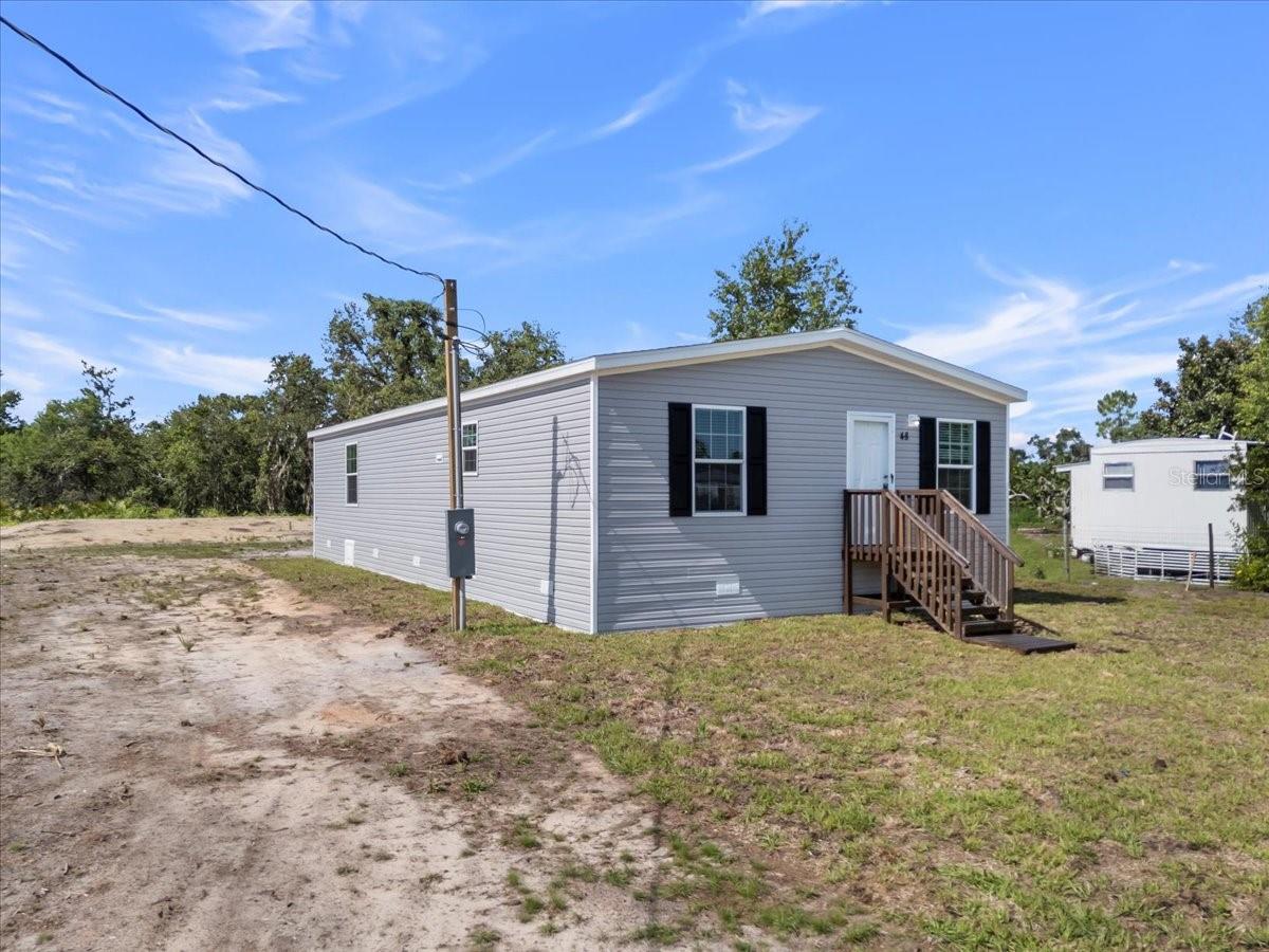 Experience the perfect blend of modern living and natural beauty with this BRAND-NEW manufactured home, situated on your own lot, you own! This beautifully designed 3-bedroom, 2-bathroom home offers a spacious, open floor plan ideal for modern living. From the moment you step inside, you'll appreciate the high-quality finishes and attention to detail with vinyl flooring throughout. The spacious living room seamlessly flows into the kitchen and dining area, perfect for entertaining guests. The master bedroom is a serene retreat, with a luxurious en-suite master bath with a dual sink vanity, shower, and a walk-in closet. The chef-inspired kitchen is equipped with brand-new stainless steel appliances, featuring a central island with a breakfast bar, shaker-style cabinets, and pantry. Two additional bedrooms provide plenty of space for family members or visiting guests. Enjoy the added convenience of a utility room, perfect for laundry and extra storage. The guest bathroom offers a tub, perfect for unwinding after a long day. Located in the Parsons Point of Hernando, FL, you'll have easy access to a variety of local amenities, including shopping centers and restaurants. This home is at a prime location with no HOA and no lot rent! Don't miss out on this incredible opportunity to make this brand-new home yours! Schedule your viewing today and experience the best of Florida living!