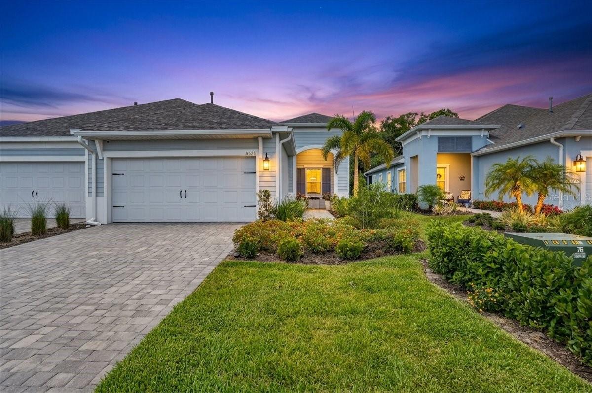 Experience effortless Florida living in this beautifully maintained Tidewater 2 Villa with Hurricane/Impact Windows by Neal Communities, ideally located in the highly sought-after Wildleaf of North River Ranch in Parrish, Florida. This thoughtfully designed 2-bedroom, 2-bath residence with a private den offers an open-concept layout that blends comfort, style, and functionality for everyday living and entertaining.

The spacious great room flows seamlessly into the dining area and chef-inspired kitchen, creating the ultimate gathering space. The well-appointed kitchen features an expansive single-level island with breakfast bar seating, wood shaker-style cabinetry with crown molding, gleaming quartz countertops, tile backsplash, and GE stainless steel appliances, including a natural gas range, vented microwave hood, dishwasher, and French door refrigerator.

Pocket sliding glass doors open to the extended covered lanai with pavers, offering the perfect indoor-outdoor living experience while overlooking a serene private preserve and water views, an ideal setting to relax and enjoy the Florida lifestyle. The owner has added Gutters to the home.

Enjoy maintenance-free villa living in the sought-after North River Ranch community, offering resort-style amenities, miles of scenic walking trails, lakes, parks, and conservation areas. Wildleaf is located within the premier master-planned community of North River Ranch, designed to provide endless opportunities for recreation, relaxation, and connection.

Residents enjoy access to three exceptional amenity centers. Camp Creek features a clubhouse, café, game room, pickleball courts, and a swim center complete with a plunge pool and water slide. Brightwood Pavilion offers a resident clubhouse, resort-style pool, state-of-the-art fitness center, game room, and playground. Riverfield Verandah includes a resort-style pool and covered outdoor patio space perfect for gathering with neighbors and friends.

Conveniently located nearby is Market Walk at North River Ranch featuring Publix, shopping, dining, banking, and everyday conveniences. The community also offers a Health-Oriented Village Center, the North River Ranch HCA Emergency Center, and a future HCA Florida Healthcare hospital.

Perfectly positioned between Tampa and St. Petersburg to the north and Lakewood Ranch and Sarasota to the south, residents enjoy easy access to world-class dining, entertainment, sports venues, cultural attractions, and Florida’s beautiful Gulf Coast beaches.