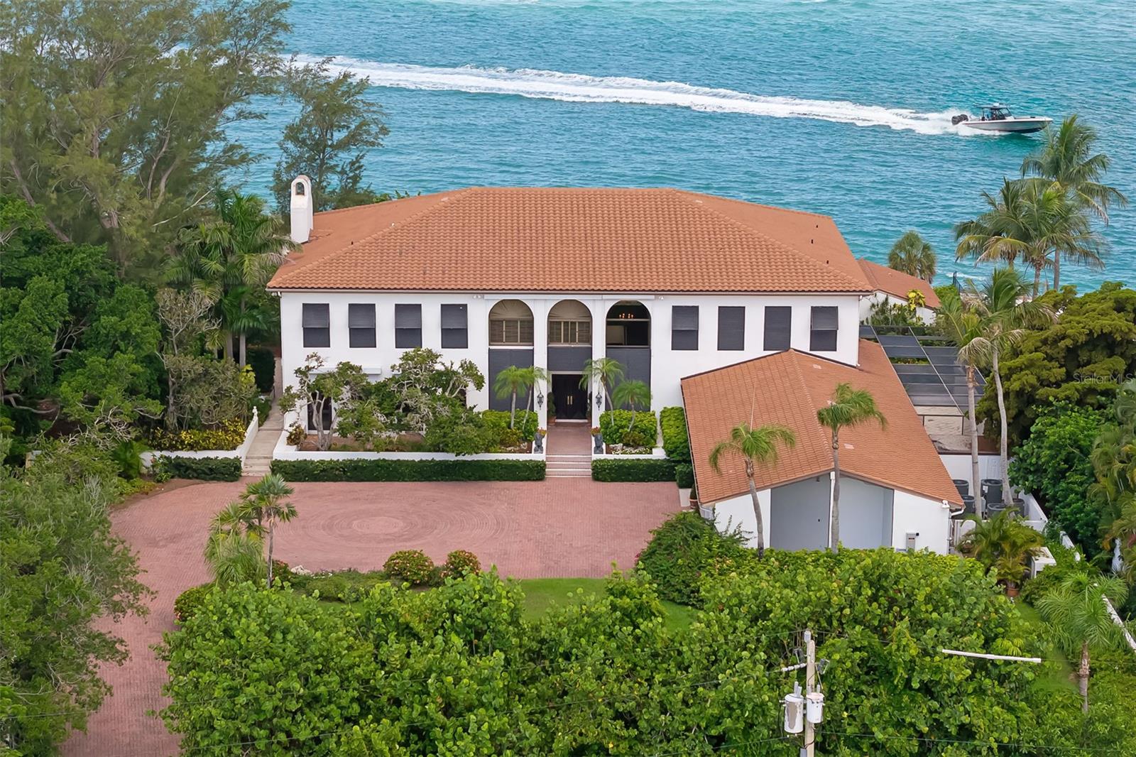 Some properties tell the story of Sarasota's evolution. Offered for the first time publicly in half a century, this waterfront estate in Lido Shores presents a rare opportunity to become the next steward of 1.34 acres with 247 feet of western shoreline. Held by only two families since 1974, both recognized for their lasting contributions to the Sarasota community, the property offers a unique connection to the people and vision that helped shape the city we know today. A rare slice of Sarasota's legacy is now ready for its next chapter.

Designed by Seibert Architects, the residence reflects an important chapter in Sarasota's architectural heritage. Encompassing more than 9,000 square feet with six bedrooms and six baths, including a library and billiards room.  This home was thoughtfully designed to embrace its waterfront setting through expansive living spaces, gathering areas and water views throughout including multiple terraces.
The generous homesite presents exceptional possibilities for restoration, renovation or the creation of a new waterfront estate. Opportunities offering this scale of Western facing water frontage, private beach access and architectural provenance are increasingly rare along Sarasota's coastline.  Offering a remarkable sense of privacy, yet just minutes from the boutiques and fine dining of St. Armands Circle, downtown Sarasota's renowned arts and cultural institutions, theaters, galleries and museums, this exceptional property also enjoys convenient access to International Airports and multiple international gateways, connecting this storied waterfront setting to destinations around the world.