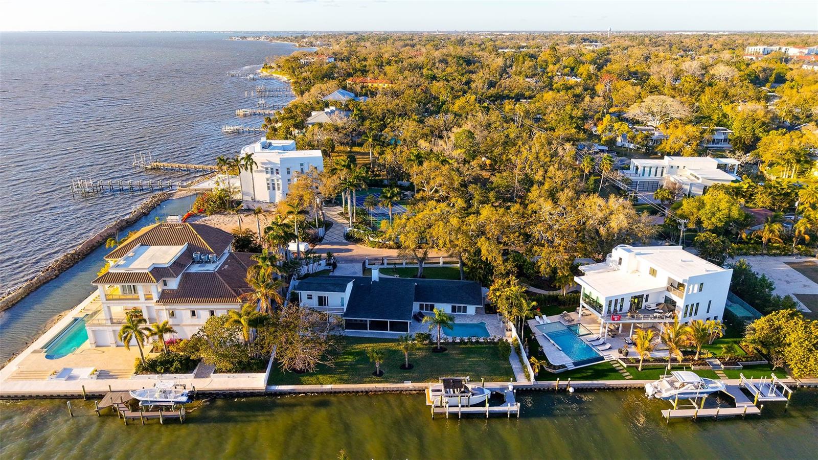 Introducing a perfectly positioned waterfront gem on Whitaker Bayou where the inlet opens up to Sarasota Bay. This charming 4BR/4BA is in the sought-after Indian Beach/Sapphire Shores community an exclusive location that captures both tranquility and convenience. The home is gated and, has been completely updated and offers stunning Bay and/or Bayou views from virtually every room. You will love the light and bright interior. A wall of windows spans through the living/dining area, opening up to the elegant pool and the large covered and screened patio area. 3 of the 4BR are ensuite, which is ideal for privacy. All of them in accordance with the theme of this property: Perfect & Seamless indoor /outdoor living! The master on the ground floor opens to the pool area, the 2nd suite opens to a large deck overlooking the Bayou and Bay and the 3rd suite (2nd floor) has a balcony that captures wonderful sunset views. Perfect for maritime enthusiasts, a beautiful extended dock, 120 foot of seawall, boatlift and immediate access to the bay. This waterfront property is also ideal for vacation rentals if your goal is to generate lucrative income. Upgrades include: new HVAC, newer roof and new water heater. A waterfront haven only steps away from cultural attractions, fine dining, and boutique shopping. Coastal living in one of Sarasota’s most desired downtown neighborhoods. Call for a private showing.