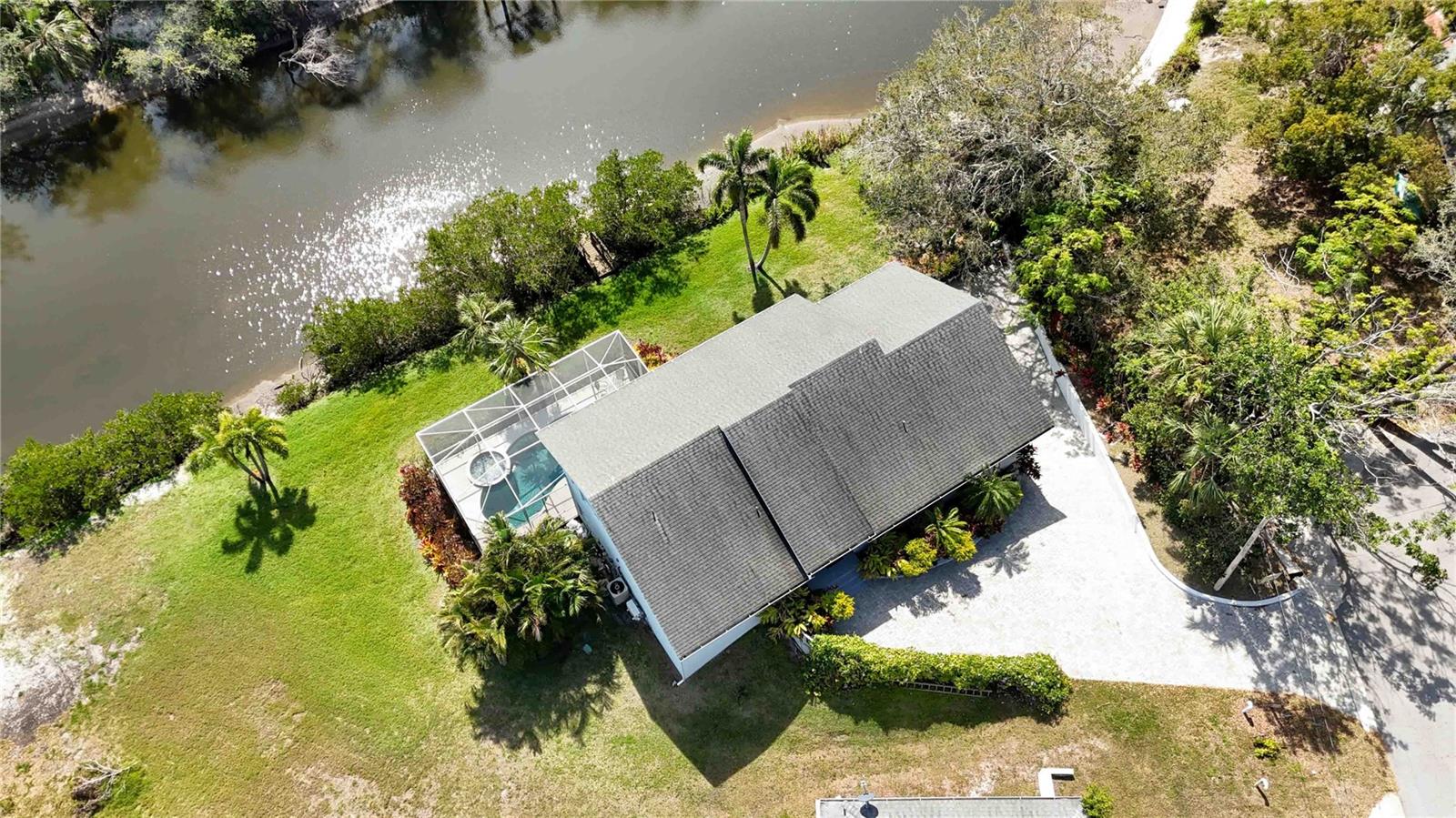 Priced below IMAPP tax evalutation of $1,280,800 Custom-built waterfront property that epitomizes modern living. This stunning 2,157 sq ft home offers 4 bedrooms and 3.5 bathrooms, along with a sleek, contemporary design characterized by clean lines and an open concept layout.

The house impresses right from the entrance, leading into a spacious living room with a wall of windows offering serene views of Phillippi Creek. The modern white kitchen is a chef's dream, featuring ample cabinetry, extensive counter space with a gas cooktop, and a large center island. Each bedroom, including a primary suite with dual closets and an en-suite bathroom, boasts natural bamboo flooring—complementing the large 30"x30" tile flooring throughout the common areas.

The massive lower level presents a flexible bonus space that opens to a pool lanai and spa, perfect for relaxation or entertainment. The property also includes a practical 20’ dock, ideal for boating enthusiasts with easy access to the intercoastal and bay despite two fixed bridges.

Additional highlights include an oversized extended garage that can accommodate two cars and recreational gear, and beautifully maintained grounds for gardening enthusiasts.

Situated in a prime Sarasota location, the property is just a short distance from essential amenities like Trader Joe’s, Sarasota Memorial Hospital, and Publix Super Market, and is close to Siesta Key's renowned beaches.

This home is being offered with the option Turn-Key furnished; perfect for anyone looking to embrace a stylish, convenient, and active Florida lifestyle.
