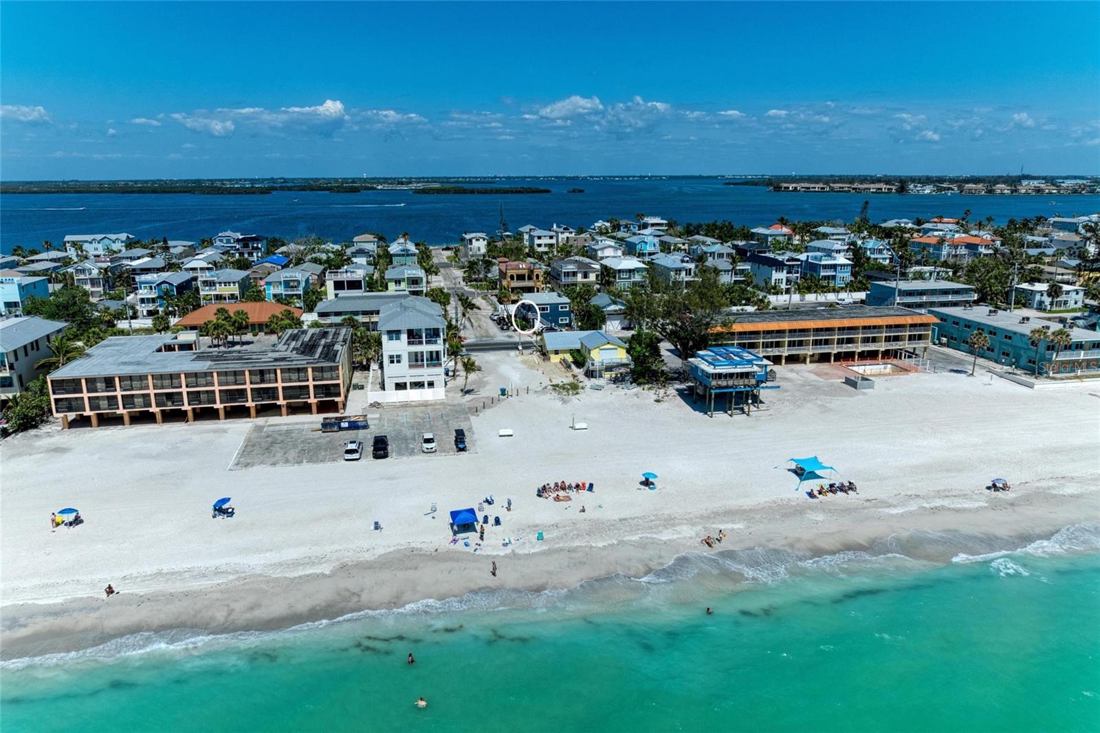 Turnkey beachside investment with a strong, proven rental history and loyal repeat guests—exceptionally positioned and priced to stand out, just steps from the sugar-white sands of the Gulf.
This beautifully updated 2-bedroom, 2-bath condo effortlessly blends coastal charm with income-producing potential in a 4-unit boutique setting. Fully renovated and offered fully furnished, the home showcases a light, airy interior with shiplap and wainscoting accents, durable luxury vinyl plank flooring, and an updated kitchen with newer appliances. A convenient laundry closet with recently replaced washer and dryer adds everyday ease. Two king bedrooms plus a sleeper sofa maximize comfort and guest capacity, while both bathrooms feature quartz countertops and refined designer finishes.

With a consistent history of repeat guests, this property is as enjoyable as it is profitable. Recent upgrades—including a new roof (2024), hurricane impact windows (2025), updated plumbing (2022), water heater and AC (2020)—provide lasting value and added peace of mind.

Begin your mornings with coffee and a sea breeze from your front porch, spend afternoons poolside or on the beach just across the street, and unwind with unforgettable Gulf sunsets. With dining, shops, parks, and the island trolley all nearby, every day feels effortlessly like a getaway.

Whether you're seeking a high-performing investment, a personal retreat, or both, this is island living at its finest.