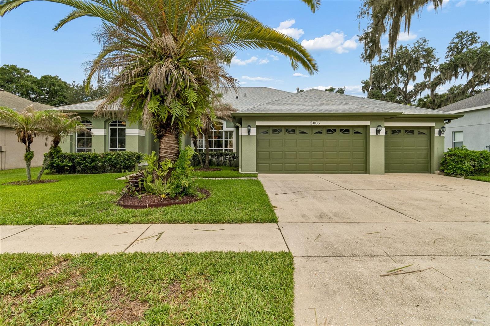 WELCOME HOME to this beautifully updated POOL HOME featuring a BRAND-NEW ROOF (2025), NEW A/C SYSTEM (2025), TWO NEW GARAGE DOOR OPENERS (2025), a freshly painted exterior, and a freshly painted interior completed in 2022. Combining timeless elegance with modern upgrades, this spacious home offers a floor plan ideal for multi-generational living including a mother-in-law suite!
As you enter through the front door, you're greeted by a formal dining room to the right and a private office with double French doors to the left. RICH HARDWOOD flooring flows throughout the formal living room, dining room, family room, and office, adding warmth and sophistication to the main living areas. These premium wood floors are built to last and can be refinished and sanded for decades of continued beauty. 
The luxurious owner's suite is privately positioned off the formal living room and serves as a true retreat. Featuring elegant marble-look tile flooring, two spacious walk-in closets, and a COMPLETELY RENOVATED spa-inspired bathroom, this space was designed for relaxation. Enjoy dual vanities with separate cabinetry offering nine drawers for storage, a large linen closet, a freestanding soaking tub that has never been used, and an oversized walk-in shower featuring dual shower heads.
At the heart of the home is the BEAUTIFUL KITCHEN overlooking the family room and dining area. Designed with both style and function in mind, the kitchen showcases 44-inch cabinetry with crown molding, nine upper cabinets, six lower cabinets, two pantry closets, recessed lighting, and a full suite of Whirlpool appliances including a GAS RANGE, microwave, dishwasher, and refrigerator. The open-concept layout creates the perfect gathering space for family and friends.
Adjacent to the kitchen is a SECONDARY OFFICE or command center complete with built-in cabinetry and desk space—ideal for working from home, organizing schedules, homework stations, or creating a convenient charging center for electronics.
The home's THREE WAY split-bedroom layout offers exceptional privacy. A separate guest or mother-in-law suite includes its own private en-suite bathroom, making it perfect for extended family or overnight guests. Bedrooms two and three are located on the opposite side of the home and share a Jack-and-Jill bathroom featuring a tub/shower combination and separate vanity area for added convenience.
Outdoor living is equally impressive. Multiple sliding glass doors fill the home with natural light and provide seamless access to the screened pool area. Three sliders open from the formal living spaces, while an additional slider connect the family room and dining area to the lanai. The sparkling pool features a custom FLORIDA GATOR logo centerpiece, creating a unique focal point for entertaining and relaxation.
Additional highlights include crown molding in the formal living and dining rooms, abundant storage throughout, a large attic storage area with pull-down access, and numerous recent upgrades that provide peace of mind for years to come.
This exceptional home offers luxury, functionality, quality craftsmanship, and major recent updates, making it a rare opportunity for buyers seeking a truly move-in-ready residence.*Room measurements on floor plan are approximate*