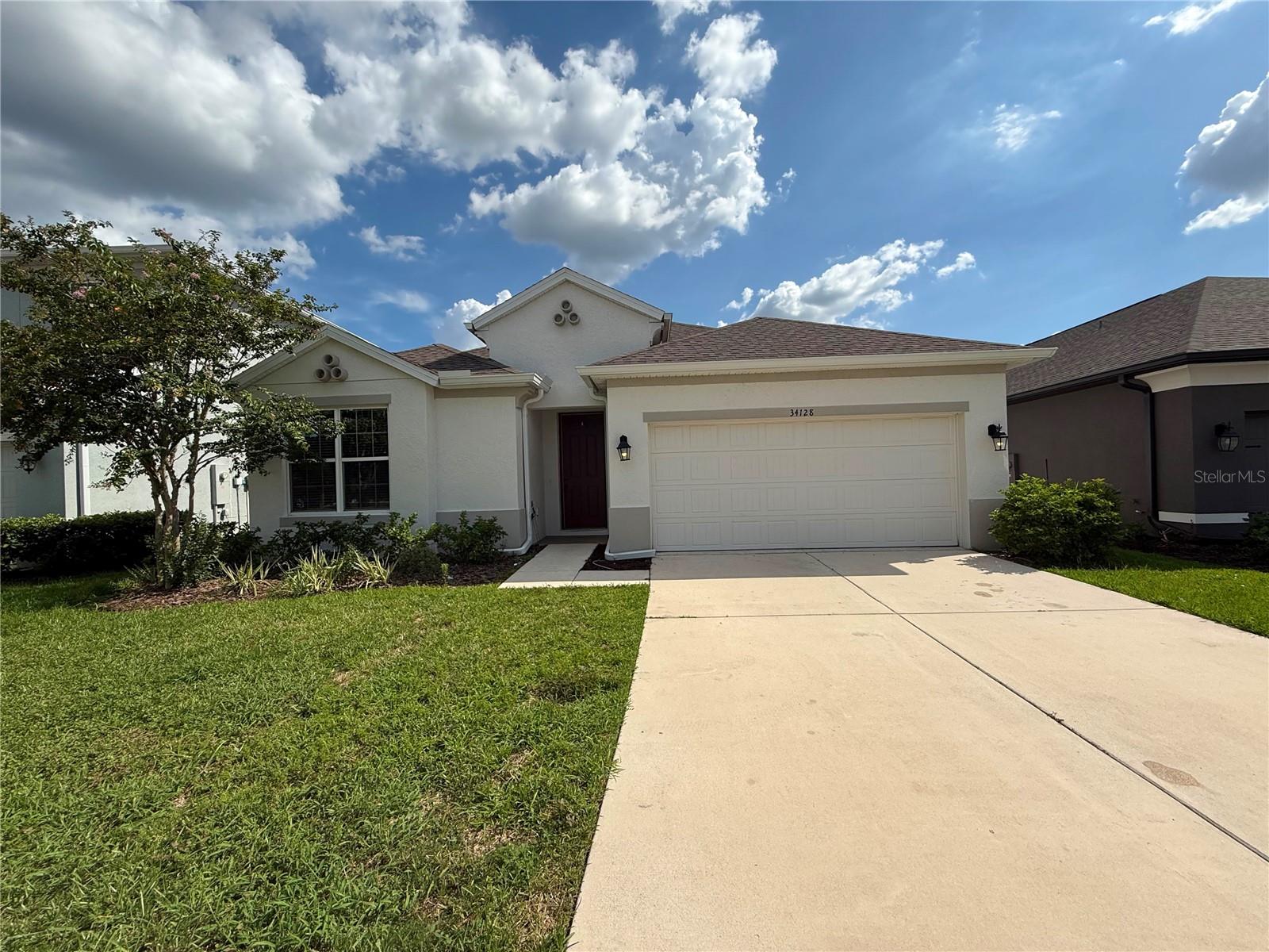 Move-in ready 4BR/3BA home with a bonus room in the highly desirable Watergrass community! Offering 2,189 square feet of thoughtfully designed living space, this home features a bright, open floor plan with fresh interior paint and brand-new luxury vinyl plank flooring in the living room, flex room, and all bedrooms. Tile flooring enhances the entry, kitchen, dining area, bathrooms, and laundry room. The spacious kitchen is appointed with granite countertops, shaker-style cabinetry, stainless steel appliances, and an impressive 9-foot island with seating for four, overlooking the great room—perfect for everyday living and entertaining. The private primary suite is tucked away at the rear of the home and offers a large walk-in closet and a spa-inspired en-suite bath. A versatile bonus/flex room provides the ideal space for a home office, playroom, gym, or media room. Relax on the covered lanai overlooking the spacious backyard. Residents of Watergrass enjoy resort-style amenities, including community pools, parks, playgrounds, and scenic walking trails. Watergrass Elementary School and a fire station are conveniently located within the community. Just minutes from Publix, Chick-fil-A, Home Depot, shopping, dining, and the Tampa Premium Outlets, with easy access to downtown Tampa and Tampa International Airport. Don't miss this opportunity to own a beautifully updated home in one of Wesley Chapel's most sought-after communities!