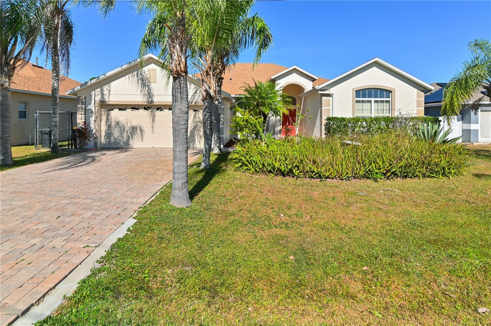 A remarkable home, impeccably maintained & cherished by its ORIGINAL OWNERS. As you approach the property, the elegant BRICK PAVERS and lush Mature Landscaping immediately catch your eye. This one-of-a-kind property is Move-In Ready with a FRESH COAT OF PAINT inside and out. NEW ROOF IN 2016. NEW HVAC IN 2017. Offering a practical layout with 4 bedrooms and 3 FULL BATHS. 3 of the bedrooms have WALK-IN CLOSETS. The OPEN CONCEPT LIVING area provides versatility for your preferred style of living and entertaining. The kitchen features well-maintained appliances, 42” Maple Cabinetry with Crown Molding and GRANITE COUNTERTOPS. Upgraded Laminate and Ceramic Tile Floors throughout, including the garage! This property also offers a unique feature for MULTI-GENERATIONAL LIVING with a separate 2 bedroom/1 bath living space for extended family or guests. Step outside onto the Screened Lanai, which leads to an extended patio and a cozy fire pit, perfect for outdoor gatherings. The backyard is FULLY FENCED and features an array of mature fruit trees and plants, including AVACADO, LOQUAT, MANGO, PAPAYA, BANANA, YUCA, AND MORE. And no rear neighbors creates a peaceful outdoor oasis. Practical touches like the Concrete border around the home, an Irrigation system on private Well water, and a Shed for additional storage add convenience to daily life. If you're looking for a comfortable, well-maintained, and versatile home with beautiful outdoor space, this property is a must-see. It combines functionality and elegance, making it the perfect place to call home. Don't miss the chance to own this meticulously cared-for home with a private paradise in your own backyard! Act now and make it yours!