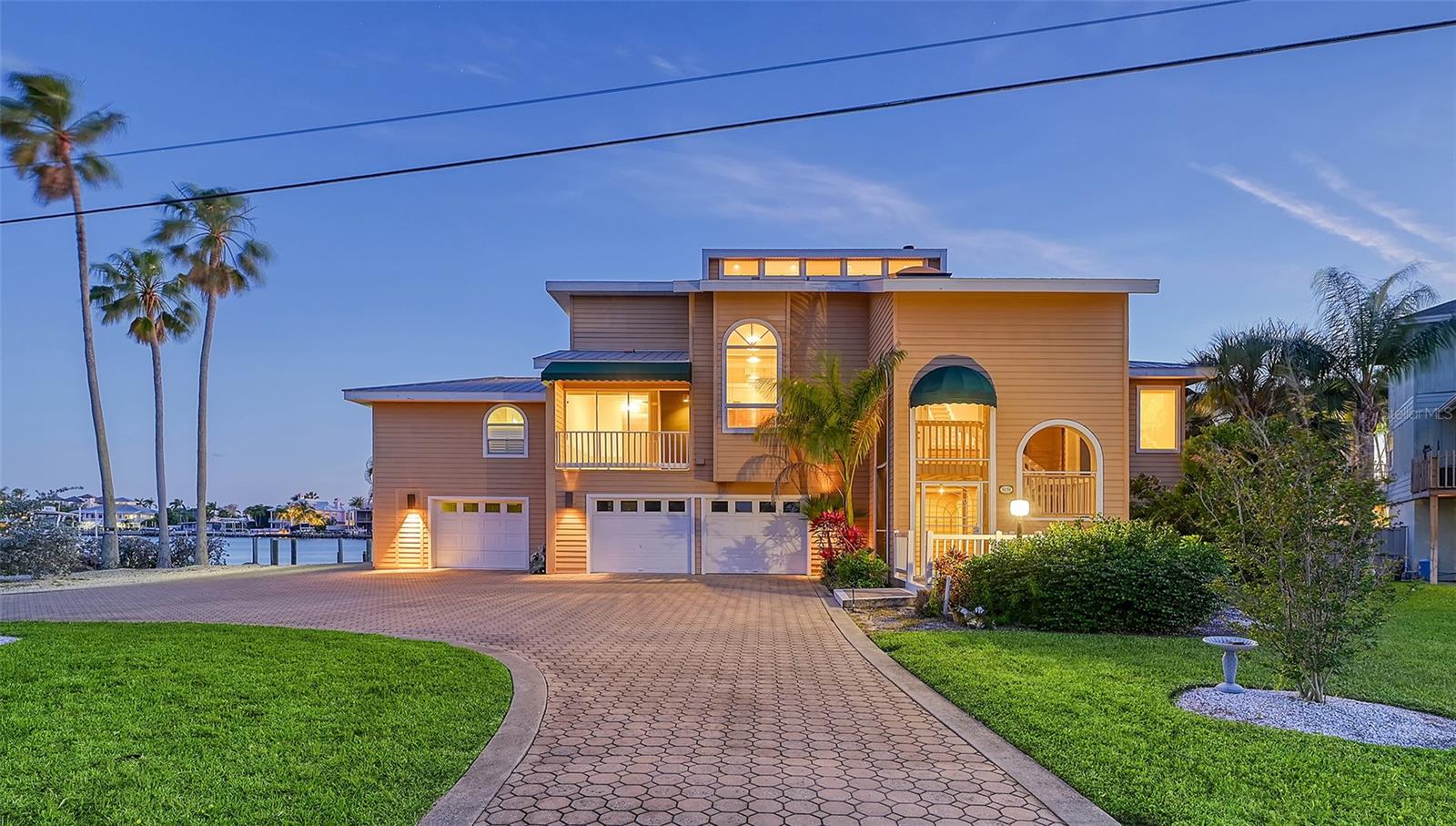 Nestled in the prestigious West of the Trail area, this waterfront estate home offers a prime location on Ringling Cove, with protected water and stunning views of Sarasota Bay. Situated next to Sun Circle Park, this exclusive property enjoys the privacy of having only one neighbor to the north. This grand three-story home boasts four bedrooms and five and a half bathrooms, with each bedroom featuring an en suite bathroom and a private balcony overlooking the water.
The second level of the home features two Master suites. The entire home is wheelchair accessible, with an elevator providing access to the main living level on the second floor. The ground floor opens up to a pool area through sliding glass doors, perfect for outdoor entertainment.
On the main living level, you'll find separate living and dining rooms, both Master Suites, and a kitchen with eat-in space and a balcony overlooking the front yard. The second living level houses two guest suites, each with its own balcony overlooking the water. A wood-burning fireplace adds warmth and charm, shared by the Living Room and one of the Master bedrooms.
The property features plantation shutters for window coverings, Oak flooring, and Birch and Cherry cabinetry throughout. Etched glass windows adorn the front, while manual crank-out windows on the third floor provide a classic touch. A boat dock offers direct access to Sarasota Bay, perfect for boating enthusiasts.
Conveniently located within walking distance to the Ringling Museum and Asolo Theater, and close to downtown Sarasota, this property offers a luxurious waterfront lifestyle in a sought-after neighborhood. This property is being sold as is, presenting an excellent opportunity for customization and personalization to suit your preferences.
