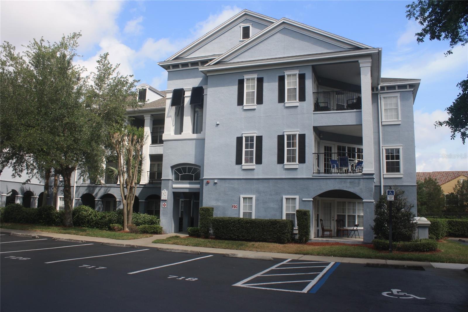 Welcome Home!  This is a top-floor unit in one of Mosaic's most recognizable buildings, a three-story blue colonial with dark shutters and covered balconies that stands out in this gated community. At 850 square feet, this one-bedroom, one-bath condo lives larger than its footprint thanks to 9-foot ceilings with crown molding, chair rail detail, and an open pass-through kitchen with breakfast bar that keeps the living space connected and airy.  The large private balcony is accessible from both the living room and bedroom, a rare feature at this price point. This kitchen includes Refrigerator, range and dishwasher for your convenience. A full-size washer and dryer are included with the unit, along with a detached storage room and one assigned parking spot. Mosaic's grand-style clubhouse features a theater room, pool table, and multiple lounging areas. The tropical pool area includes a gas grill, lush trellis, and a huge screened patio with TVs and a summer kitchen. Additional amenities include a state-of-the-art fitness center, sand volleyball court, tennis court, a play area, and valet trash service. The 27-building community is fully gated for privacy.
This location couldn't be more convenient, minutes to the Mall at Millenia, I-4, the Florida Turnpike, Downtown Orlando, and other Central Florida attractions.