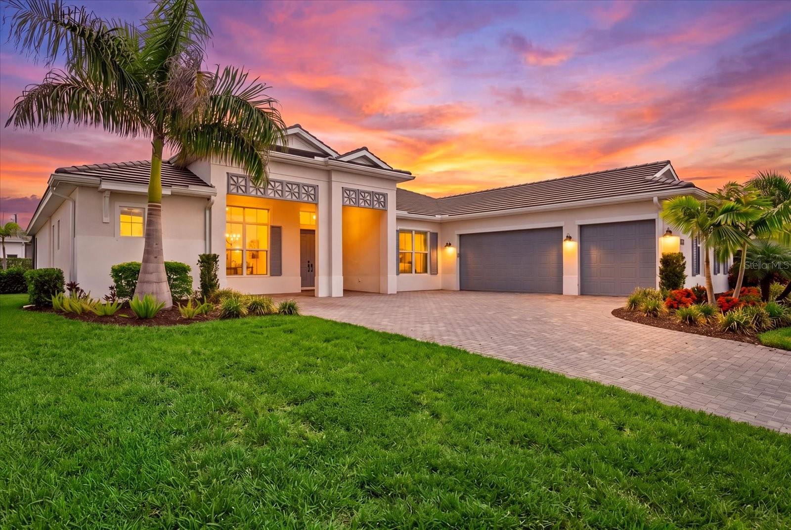 Virtually Staged. Begin each day with tranquil pond views and spectacular Florida sunrises from this exceptional Toll Brothers Island-inspired luxury residence. Built on the highly sought-after Maxwell floor plan, this beautifully appointed Toll Brothers home offers four bedrooms, four-and-a-half bathrooms, a private office, and more than $300,000 in luxury upgrades, creating a residence that is truly move-in ready.
Inside, soaring 12-foot coffered ceilings, expansive windows, and a thoughtfully designed open floor plan fill the home with natural light while creating an effortless flow for both everyday living and elegant entertaining. The gourmet kitchen is beautifully appointed with contemporary cabinetry, an oversized premium quartz island, countertops and backsplash and a full suite of JennAir Professional appliances. The adjoining great room and dining area transition seamlessly to the outdoor living spaces, delivering exceptional indoor-outdoor living.
Privately situated, the owner's suite is a true spa-inspired retreat featuring dual custom walk-in closets, a freestanding soaking tub, an oversized walk-in shower, and designer tile finishes. Each additional bedroom includes its own ensuite bath, while the thoughtfully designed split-bedroom floor plan provides exceptional privacy and comfort for family and guests.
Designed to embrace Florida's coveted outdoor lifestyle, the expanded covered lanai spans the entire rear of the home and captures peaceful pond views, creating an exceptional setting for relaxing or entertaining. Completed in 2026, the custom-designed pool and luxurious spa are surrounded by an expansive premium marble deck, creating a private resort-style retreat. A fully equipped outdoor kitchen with a built-in grill, cooktop, refrigerator, and sink makes outdoor dining and entertaining effortless while overlooking the tranquil waterfront.
Additional highlights include hurricane-impact windows throughout, roller shades, upgraded designer kitchen and bath fixtures, an expansive laundry room with a utility sink, generous counter space, cabinetry, and numerous thoughtful upgrades that enhance both comfort and functionality.
Located within the gated, maintenance-included community of The Isles at Lakewood Ranch, residents enjoy an exceptional collection of resort-style amenities, including a state-of-the-art clubhouse, fitness center, yoga studio, resort-style pool and spa, tennis, pickleball courts, basketball court, scenic boardwalk, fishing pier, dog park, playground, and an active calendar of community events.
Ideally situated just minutes from Waterside Place, and UTC shops, residents enjoy convenient access to exceptional dining, shopping, entertainment, and everyday conveniences. Combining an outstanding floor plan, more than $300,000 in recent upgrades, tranquil waterfront views, and an exceptional location, this beautifully maintained residence presents a rare opportunity to experience one of Lakewood Ranch's premier luxury lifestyles.