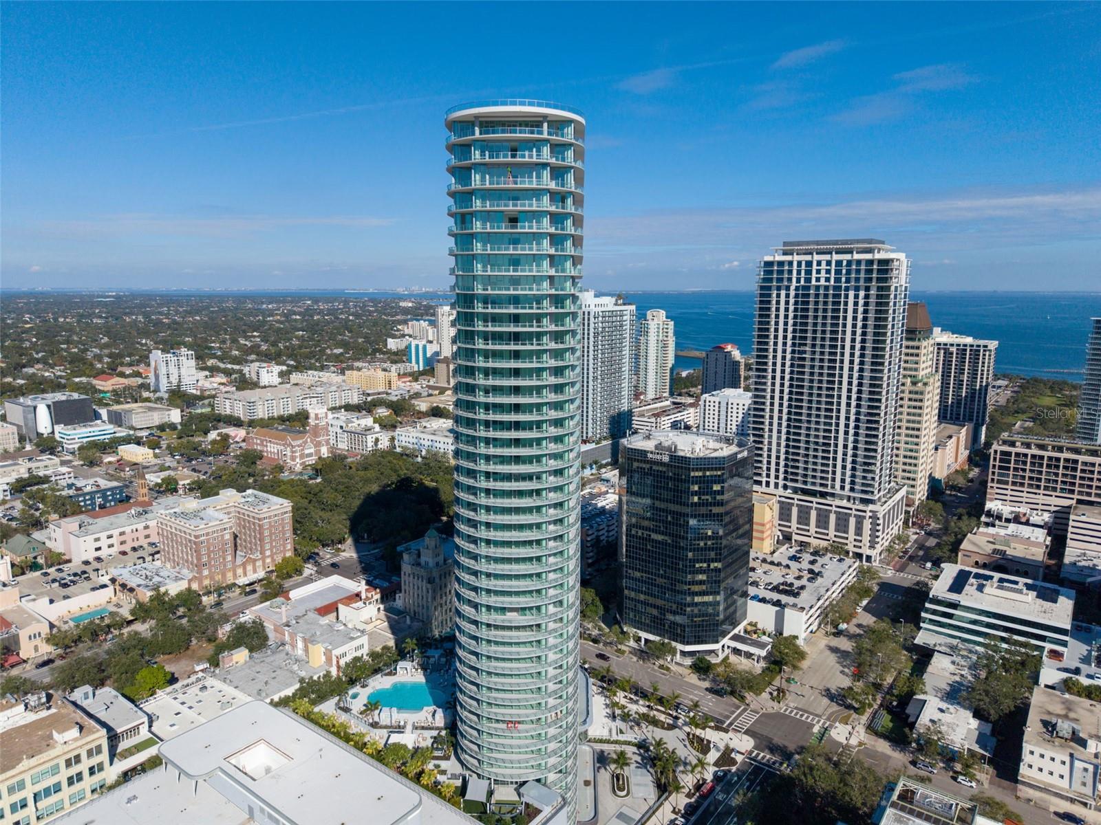 Perfectly positioned on the southwest corner of the newly completed 400 Central, Residence 3401
captures one of the building’s most spectacular vantage points. Thanks to the tower’s unique
angled design and the residence’s coveted southwest orientation, the home enjoys remarkable
panoramic views stretching across Tampa Bay and all the way to the Gulf of Mexico. Framing these
views is an exceptional feature—an expansive wraparound terrace that spans the entire outer edge
of the residence, creating a seamless connection between indoor and outdoor living and offering
multiple vantage points for sunrise, sunset, and the downtown skyline.
This expansive 3-bedroom, 3.5-bath residence offers approximately 2,658 square feet of interior
living space complemented by over 1,000 square feet of terrace space, delivering more than 3,600
square feet of total living area. A standout feature of this residence is that every bedroom, in
addition to the main living areas, offers direct access to its own private balcony space, allowing
each room to enjoy natural light, fresh air, and its own unique perspective of the surrounding views.
Inside, floor-to-ceiling glass walls flood the open-concept great room and dining areas with natural
light while seamlessly extending the living experience to the terraces. The result is a home that
feels both spacious and inviting, ideal for entertaining or enjoying quiet evenings overlooking the
water and city lights.
The designer kitchen features sleek European-style cabinetry, quartz countertops with a waterfall
island, matching quartz backsplash, and a premium JennAir appliance package, including a gas
cooktop, wall oven and microwave combination, counter-depth refrigerator, and integrated
dishwasher.
The primary suite serves as a private retreat with direct terrace access and a spa-inspired bathroom
featuring a freestanding soaking tub, frameless glass shower with rain and handheld fixtures, quartz
vanity with dual sinks, and Grohe fixtures throughout.
Additional features include porcelain tile flooring in the main living areas, premium carpeting in the
bedrooms, solid core interior doors, recessed LED lighting, high-efficiency climate control, and a
full-size Whirlpool washer and dryer.
Residents of 400 Central enjoy resort-style amenities, sophisticated design, and immediate access
to downtown St. Petersburg’s waterfront parks, dining, arts venues, and vibrant urban lifestyle.
Residence 3401 represents a rare opportunity to own a premier corner residence with sweeping
water views, exceptional outdoor living, and private balcony access from every bedroom