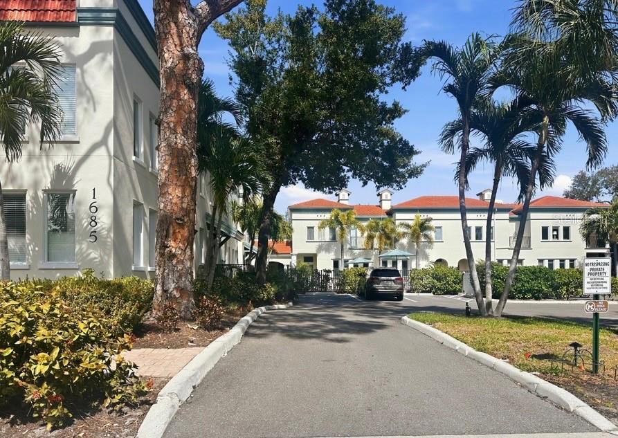 Welcome to the Enchanting, Sarasota's best-kept secret Townhome/Villa Community known as The Villas on Laurel. Experience the perfect blend of downtown energy and private living in this beautifully appointed 3-bedroom, 3-bath townhome with a loft office, ideally located in the highly sought-after Laurel Park neighborhood, just steps from the heart of Downtown Sarasota.  Inside, soaring ceilings and engineered hardwood floors create a light-filled, inviting atmosphere across both levels. The spacious open-concept great room is ideal for entertaining and features abundant windows and seamless flow into the chef-inspired kitchen, complete with a gas range, granite countertops, stainless-steel appliances, and generous cabinetry. The first floor also includes a guest bedroom, full bathroom, dining area, and convenient under-stair storage.  An elegant iron staircase leads upstairs to a versatile loft-style office, laundry room, a second guest en-suite, and the luxurious primary suite. The primary retreat offers a large walk-in closet, dual-sink granite vanity, spa-style stone and glass walk-in shower, and private water closet, creating a spacious and relaxing sanctuary.  This home is loaded with high-value upgrades, including BRAND NEW Clay Tile Roof, BRAND NEW HVAC System (Dual-Zoned); Tankless water heater, impact windows, smart wireless lighting (app controlled), high-end designer window treatments throughout and much more.  Enjoy the maintenance-free lifestyle of The Villas on Laurel, a charming courtyard-style community featuring newly added mature landscaping, a resurfaced sparkling pool, shared air-conditioned storage and a freshly completed exterior paint project for the entire complex.  Living in Laurel Park—often called Sarasota’s “Most Charming Downtown Neighborhood”—means you are just moments from Main Street dining, boutique shopping, Selby Gardens, Burns Court Cinema, galleries, and local cafés, all just steps away from your doorstep.  The property includes two designated parking spaces plus additional off-street parking for added convenience.  Rarely available and perfectly located—this private downtown retreat will not last long. Schedule your private showing today!
