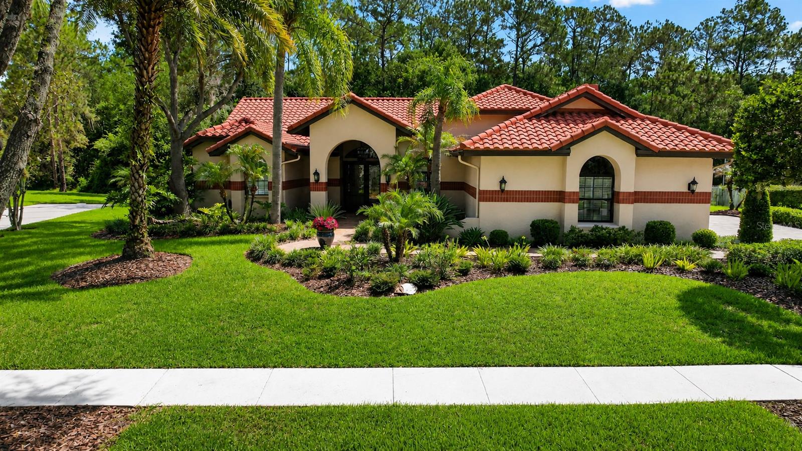 This impeccable home is priced below appraised value and is located within the 24-hour manned-supervised gates of the prestigious Hunter’s Green Golf and Country Club Community and nestled within the sought-after neighborhood of Magnolia Chase.   This exceptional residence is a rare find, offering the perfect blend of luxury, privacy, and Florida living.
Meticulously maintained and beautifully renovated, this elegant home is distinguished by its classic terra-cotta tile roof, impeccable craftsmanship throughout, and attention to every detail. The thoughtfully designed floor plan is centered around a stunning custom designed Adalay kitchen featuring high-end finishes, superior-quality cabinetry, and exceptional functionality. The premium, built-in appliances include a Sub-Zero refrigerator/freezer, a gas DCS/Fisher & Paykel 6-burner range with 2 ovens, and a DCS/Fisher & Paykel dishwasher and microwave. This stunning kitchen is accented with double ogee marble countertops and a Boos center butcher-block island.
Three sets of French doors create a seamless transition from the interior living spaces to an expansive and private outdoor oasis which overlook tranquil conservation views. Designed for year-round entertaining, the outdoor retreat features a fully equipped Alfresco kitchen, a beautifully renovated pool and spa, a newer pool cage, and elegant travertine in a French patterned stone design.
Inside, you'll find hardwood and tile flooring throughout, plantation shutters, new pewter hardware, replacement windows, and a striking electric fireplace with a stacked-stone surround. The tile roof was replaced in 2016. 
Additional features include a paver driveway and walkway, renovated garage interior with Integrity concrete flooring and built in closets and cabinets for ample storage, elegant entry double doors and sidelights, and beautifully landscaped grounds that create outstanding curb appeal. 
 
Select furnishings are negotiable, making this truly move-in ready home an exceptional opportunity.
Beyond the home, residents enjoy an unmatched lifestyle within Hunter's Green community. Amenities include parks, playgrounds, basketball courts, soccer and baseball fields, lighted tennis and pickleball courts, sand volleyball courts, an off-leash dog park, dedicated bike lanes, picnic areas, and a scenic jogging trail with a 15-station fitness circuit. Nature lovers will appreciate direct access to the adjacent 17,000-acre Flatwoods Preserve, while families benefit from the community's highly rated elementary school.
For those seeking an elevated country club lifestyle, optional membership to Hunter's Green Country Club offers access to an 18-hole Tom Fazio-designed championship golf course, world-class tennis facilities, a state-of-the-art fitness center, resort-style swimming pool, and exceptional dining.

This remarkable home combines timeless elegance, modern updates, exceptional privacy, and resort-style amenities in one of Tampa's most desirable gated communities.  Hunter's Green is centrally located near all the conveniences that New Tampa has to offer such as easy access to I-75, USF, New Tampa Performing Arts Center, multiple hospitals, excellent schools, and an ample selection of restaurants and shopping options.  Don't miss this rare opportunity to own one of Magnolia Chase's finest homes. Schedule your private showing today and discover the very best of Florida living.