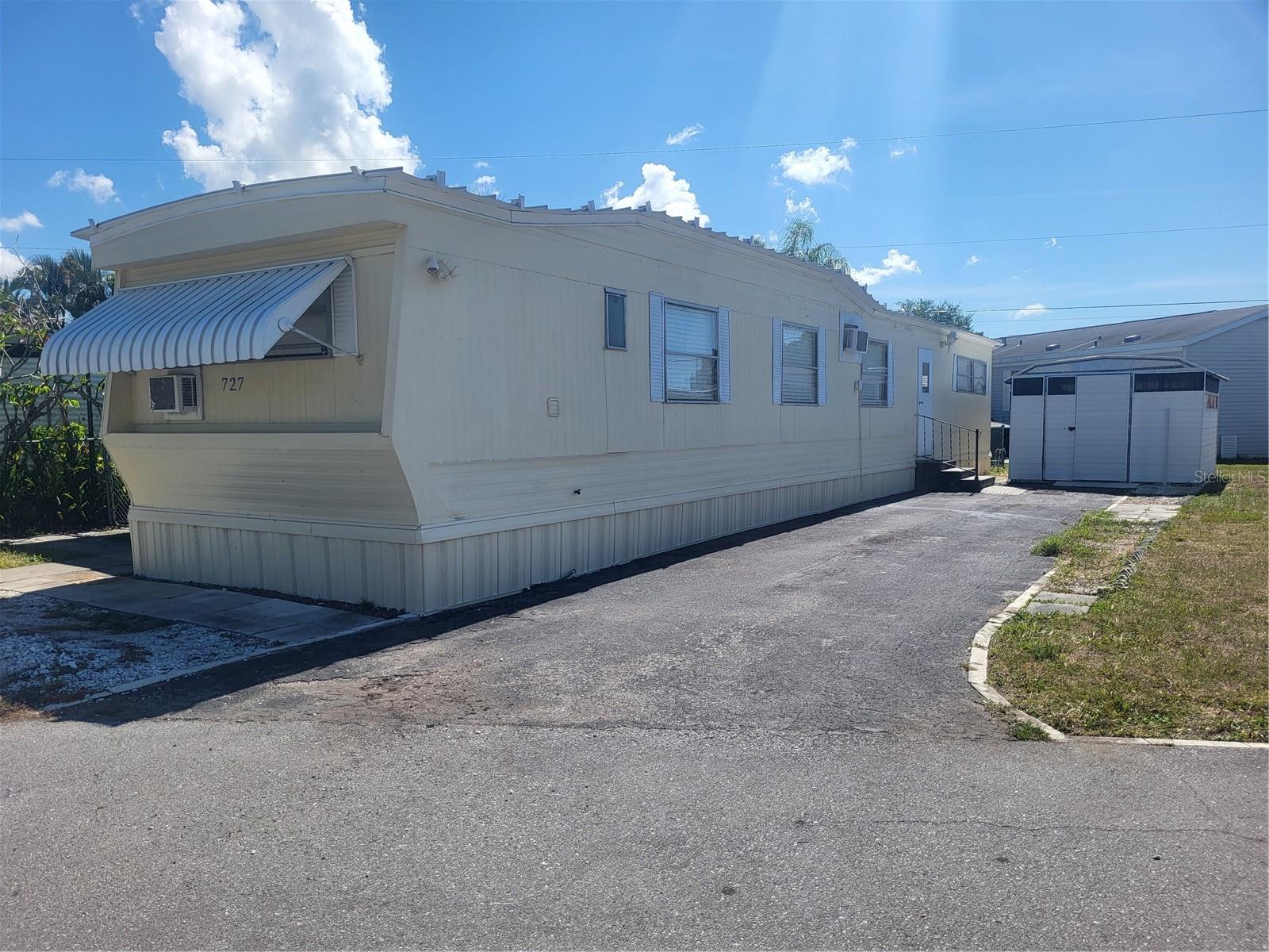 2/1 with lanai and storage shed in Holiday Village.  Located on 7th Street with a view of the greenbelt as you sit in the screened lanai enjoying the quiet.   Minutes to Madeira Beach, Seminole City Center, adjacent to the Pinellas Trail for walking, biking to Downtown St. Pete or to Tarpon Springs going west.  Public transportation near by.   No LOT RENT, own the lot share and pay only community association fee of $160/mthly (includes water, sewer and lawn maintenance.  Approval required.  Cash.  No renting/leasing.