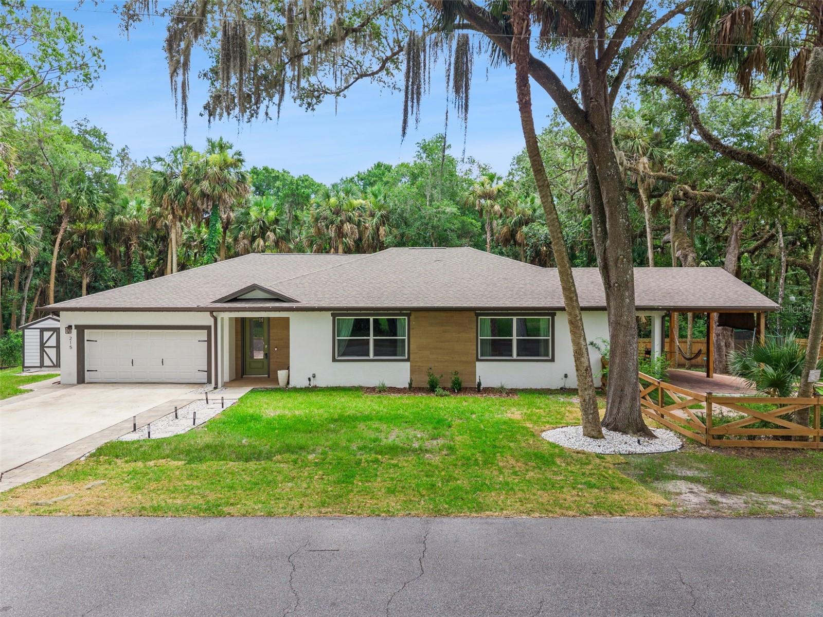 Welcome to this stunning 2025 new construction home situated on a spacious corner lot in the heart of DeBary. Featuring a bright, open-concept floor plan, this home offers modern style and functional living with an inviting electric fireplace as the focal point of the living area. Spacious MASTER SUITE with ENSUITE.  Bedrooms 2 and 3 are connected by a convenient Jack-and-Jill bathroom, while the spacious covered patio with a fully equipped outdoor kitchen creates the perfect space for entertaining. Conveniently located near shopping, dining, parks, SunRail, and major highways, this move-in-ready home offers the perfect combination of comfort, style, and location.