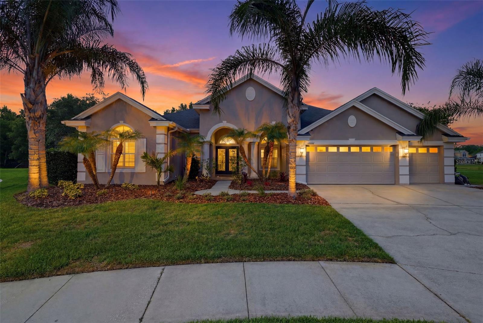 This is the kind of home buyers wait years for. Located within the gated enclave of Fairgate, a charming subdivision known for having just one winding road, stately homes, and oversized homesites, this exceptional Nohl Crest pool home offers a rare combination of space, privacy, timeless craftsmanship, and flexible living on what might be the LARGEST LOT IN SEVEN OAKS. Situated on nearly half an acre at the end of a quiet cul-de-sac, the property enjoys breathtaking pond and conservation views, creating a picturesque setting that feels both peaceful and expansive. From the moment you step through the grand double-door entry, soaring ceilings, abundant natural light, and stunning views of the pool and backyard create an unforgettable first impression.
With a rare TWO ensuites, this floor plan is designed with both everyday living and entertaining in mind, the sprawling floor plan offers 5 bedrooms, 4 full bathrooms, a dedicated office and bonus room. 
At the heart of the home, the chef's kitchen is both beautiful and functional. Thoughtfully designed with built-in double ovens, a statement range hood, copper farmhouse sink, center island, matching Samsung appliances, an oversized breakfast bar, soaring 42-inch cabinetry, and Nohl Crest's signature seamless bay window, this space was built for gathering. A massive walk-in pantry provides storage, while the open layout allows the kitchen to flow effortlessly into the surrounding living spaces.
The spacious primary ensuite serves as a private retreat with room for a sitting area and featuring direct access to the lanai and pool. The bright bathroom offers dual vanities, a soaking tub, walk-in shower, and generous proportions throughout. A desirable split-bedroom layout enhances privacy for family and guests.
Throughout the home, thoughtful upgrades and details abound, including a brand new tankless water heater, newer flooring, main HVAC, and roof. Elegant French doors add character and functionality to both the office and bonus room, while the plantation shutters, crown molding, designer accent walls add sophistication and style throughout. Even the oversized laundry room has been beautifully appointed with matching granite countertops and cabinetry, while the highly sought-after mudroom off the garage adds everyday convenience. 
Outside, multiple sliding glass doors create a seamless connection between indoor and outdoor living. The expansive travertine lanai overlooks the sparkling saltwater pool and fully fenced backyard. With nearly half an acre to enjoy, there is room to entertain, play, garden, host backyard football games, let pets roam freely, or simply relax and enjoy the privacy and beauty. 
Seven Oaks is more than a neighborhood. It's a lifestyle. Residents enjoy resort style amenities including pools, cabanas, playgrounds, sports courts, walking trails, a state-of-the-art fitness center, and a beautiful clubhouse with a café, theater, and event spaces. Known for its welcoming atmosphere and strong sense of community, Seven Oaks offers the rare feeling of living in a close-knit, amenity-rich retreat while remaining just minutes from top rated schools, shopping, dining, hospitals, and major conveniences.