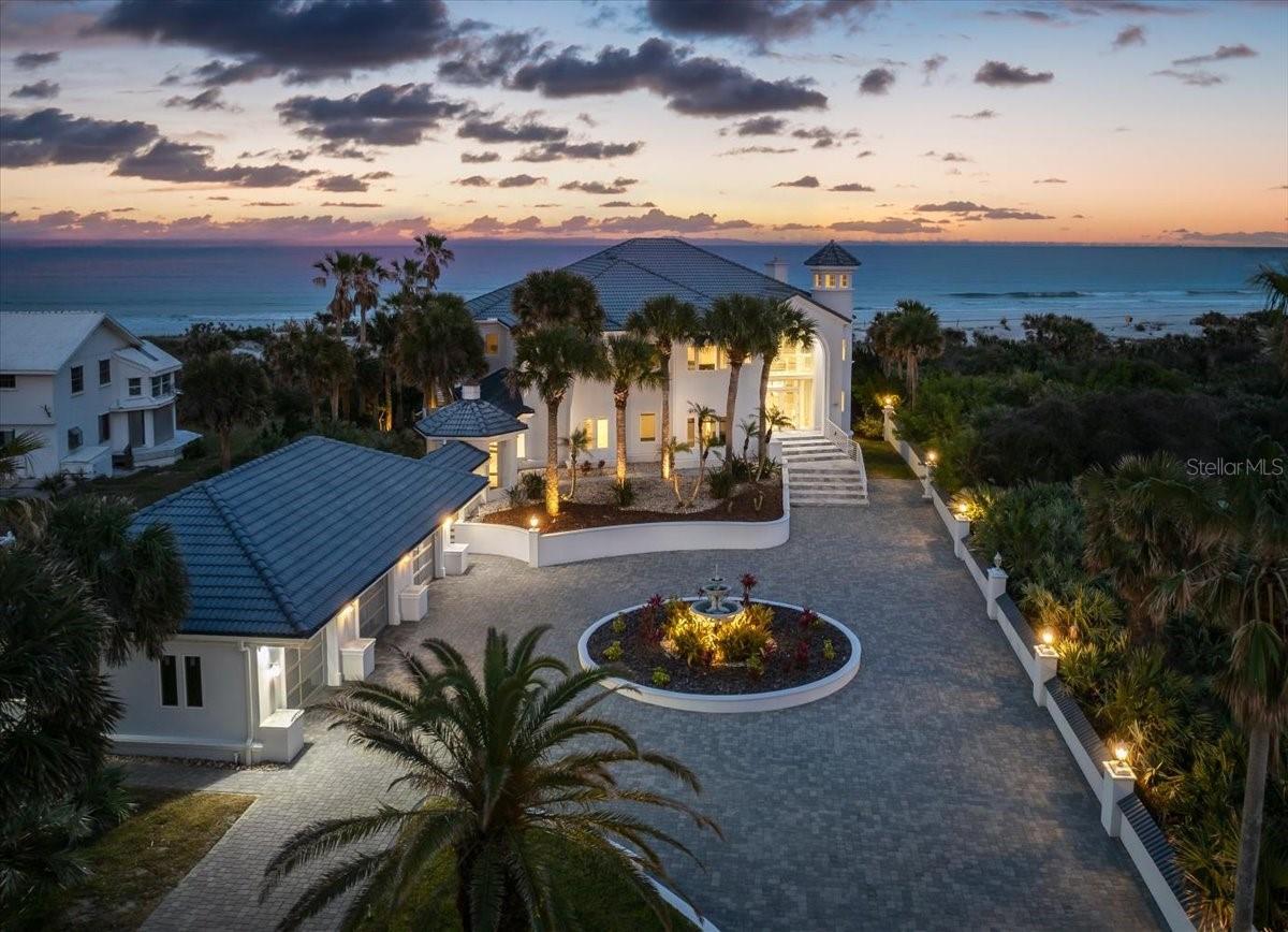Unparalleled Oceanfront Luxury - A Gated Estate Like No Other! Step into a world of unrivaled elegance and breathtaking beauty with this incredible oceanfront estate. Nestled in a premier location just steps from the iconic Ponce Inlet Lighthouse and the serene Disappearing Island, this magnificent property offers an extraordinary blend of luxury, sophistication, and coastal charm. As you enter through the private gates, a stunning paver courtyard welcomes you to a residence that exudes grandeur at every turn. Inside, superb design and stellar architecture set the stage for an unforgettable living experience. The home boasts over 7,500 sq. ft. of meticulously designed living space, featuring 5 spacious bedrooms, 5 beautifully updated baths, and 1 half bath. From the moment you step inside, exquisite details captivate the eye - from grand coffered ceilings and marble floors throughout the main living areas to new impact windows, custom railings, and impressive light fixtures. The extensive use of travertine enhances the estate's luxurious ambiance, placing it in a league of its own. Breathtaking Views & Exceptional Features such as panoramic ocean views greet you from nearly every room, allowing you to wake up to the sound of waves crashing and stunning sunrises. A staircase leads to a majestic turret, offering unparalleled 360-degree views as far as the eye can see. A full basement theater with a wet bar and full bath provides the perfect space for entertaining in style. The galley-style chef's kitchen is a dream, featuring a wet bar, massive center island, breakfast bar, and eat-in area overlooking the ocean. The travertine and marble fireplace serves as a statement piece in the grand living area, adding warmth and elegance. The second story is home to an opulent primary suite, complete with a private sitting area, spa-like master bath, and a sprawling travertine balcony where you can start your mornings with a cup of coffee and the soothing sight of the surf. Seamlessly blending indoor and outdoor living, this estate offers commanding ocean views through walls of glass, leading to expansive outdoor spaces designed for relaxation and entertainment. Enjoy the saltwater black-finished pool and patio areas, where smiling weather invites you to unwind and soak up the coastal breeze. With a private walkway through the dunes, the beach is quite literally your backyard-your slice of paradise awaits! Don't miss this once-in-a-lifetime opportunity to own a prestigious oceanfront estate that defines coastal luxury living! Schedule your private tour today!
Square footage received from tax rolls. All information recorded in the MLS intended to be accurate but cannot be guaranteed.