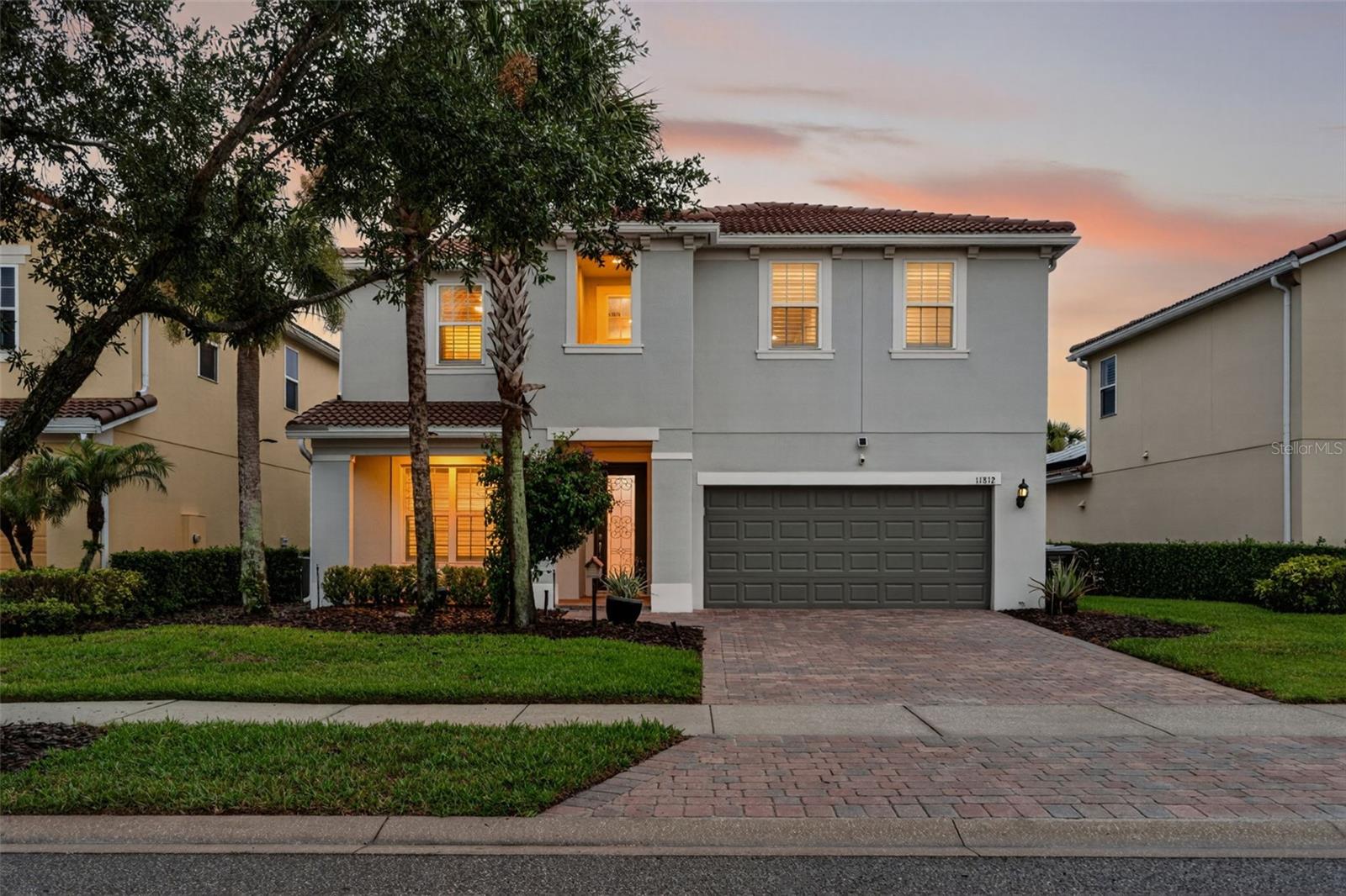 Experience an exceptional standard of living within the guard-gated community of VillageWalk at Lake Nona, one of Central Florida's most sought-after master-planned communities. Perfectly positioned on a private homesite, this beautifully maintained and extensively upgraded Cyprus model offers an impressive blend of sophistication, comfort and resort-inspired living. Further enhancing the home, fully paid solar panels contribute to exceptional energy efficiency and significantly reduced electric costs. Thoughtfully designed for both everyday living and effortless entertaining, the residence features a spacious and functional floor plan with the primary suite conveniently located on the first floor, along with a dedicated office, expansive great room and laundry room. The gourmet kitchen is appointed with custom cabinetry, granite countertops, abundant workspace and opens seamlessly to the home's inviting living spaces. The second level features three additional bedrooms and a spacious loft, thoughtfully designed to provide versatility for a variety of lifestyle needs. This exceptional residence is distinguished by numerous custom enhancements throughout, including designer closet systems, elegant finishes, a water-softening system and a stunning custom-built bar that creates the perfect setting for entertaining family and guests. A summer kitchen and screened-in lanai extend the living space outdoors, providing a peaceful retreat to enjoy Florida's year-round lifestyle. VillageWalk residents enjoy an unparalleled lifestyle with an extraordinary collection of amenities, including resort and lap pools, a state-of-the-art fitness center, tennis and basketball courts, scenic trails, a lakeside gazebo, playgrounds, event spaces, a café and deli market, a gas station, a post office and numerous social activities throughout the year. Ideally located within the vibrant Lake Nona community, residents enjoy convenient access to Medical City, Orlando International Airport, premier dining and shopping destinations and Orlando's world-renowned attractions. Combining luxury, conveniences and an exceptional amenity-rich lifestyle, this remarkable residence presents a rare opportunity to experience the very best of Lake Nona living.