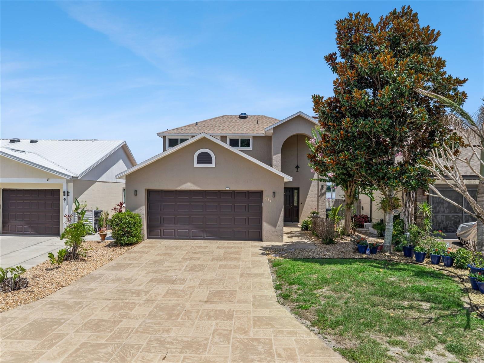 PRESENTING A BEAUTIFUL LAKEFRONT RETREAT ON LAKE DEXTER! Welcome to this charming 3 BD / 2.5 BA two-story residence that offers stunning water views, modern updates, and the perfect blend of comfort and Florida lakefront living. The spacious living room features a cozy gas fireplace and flows seamlessly into the beautifully remodeled kitchen and a convenient dining area. Bathrooms have been tastefully updated, while all windows have been replaced with energy-efficient double-pane windows. The primary suite offers a unique private balcony overlooking Lake Dexter, creating the perfect spot to enjoy peaceful lake views. Additional features include an air-conditioned sun room and a relaxing expansive private patio for outdoor enjoyment. Step outside to experience the true highlight of the property—direct access to Lake Dexter with a large private dock and beautiful beach area, ideal for boating, fishing, kayaking, or simply soaking in the waterfront scenery. Combining tasteful updates, inviting living spaces, and exceptional lakefront amenities, this property offers an outstanding opportunity to enjoy the Florida lifestyle at its finest.