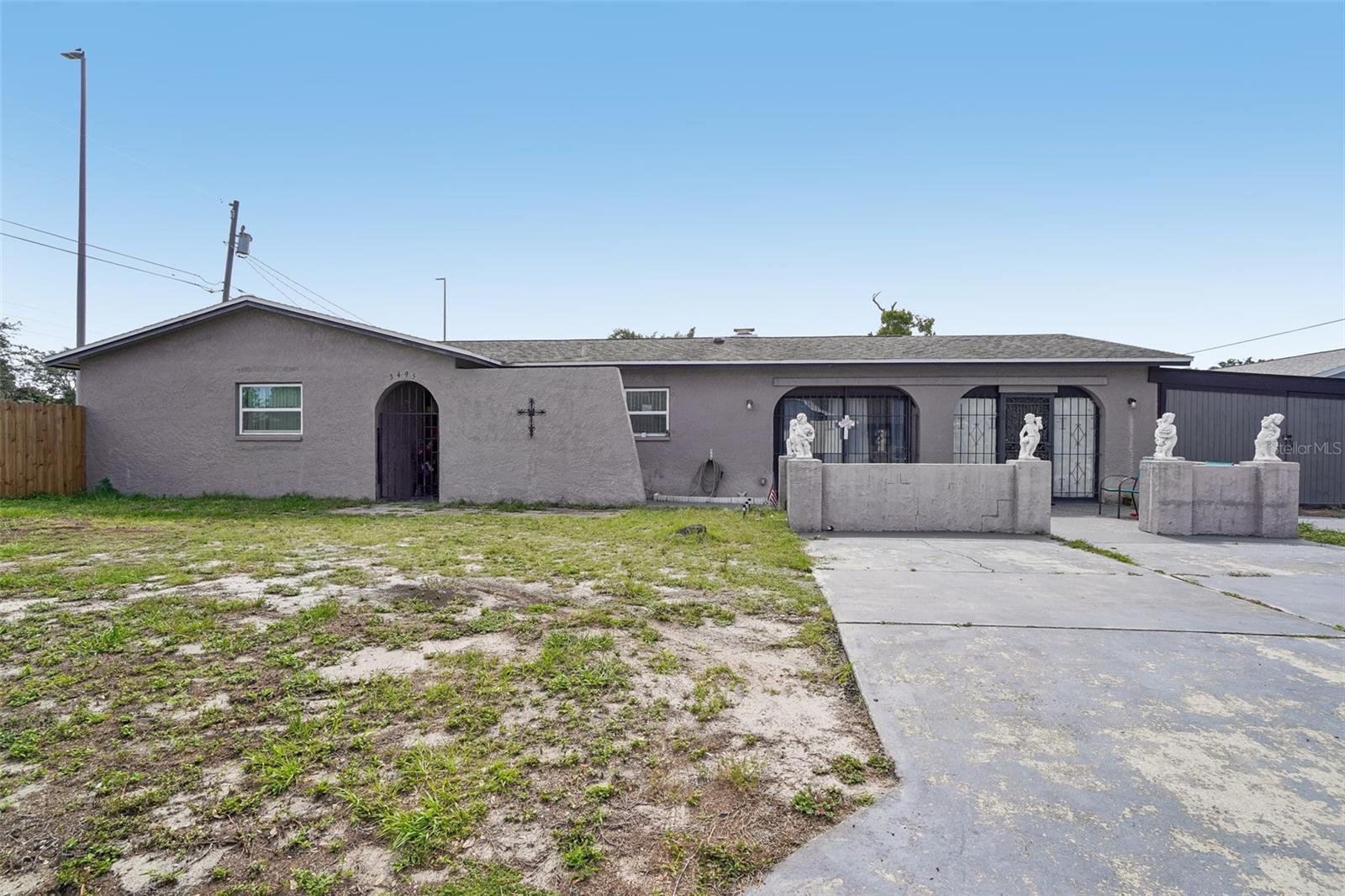 Discover comfort, flexibility, and the freedom of no HOA in this inviting 4-bedroom, 2-bath home. The bright and open great room creates a welcoming space for everyday living and entertaining. The kitchen offers stainless steel appliances, ample counter space, and multiple dining options to suit your lifestyle, while the living room fireplace serves as a warm and stylish focal point.

The spacious primary suite features an ensuite bathroom and a walk-in closet, providing a private retreat at the end of the day. Three additional bedrooms share a full bath, with one bedroom offering its own exterior entrance, ideal for a variety of living arrangements, workspace needs, or guest privacy.

Outside, enjoy a fenced backyard complete with an above-ground pool, creating the perfect setting for relaxing, entertaining, or enjoying the outdoors. A shed/carport provide added convenience for equipment, and storage needs. Conveniently located near shopping, dining, parks, and major roadways, this home offers easy access to everything the area has to offer.

Located in unincorporated Dunedin in a non-flood zone, with direct access to the Dunedin Causeway, Honeymoon Island and Caladesi Island just 4 miles away, and a quick drive to downtown Dunedin, this home is perfectly positioned for seasonal use or short-term rentals. With no HOA, versatile living spaces, and a prime location near some of Florida's most sought-after coastal destinations, this property is ready for its next chapter!